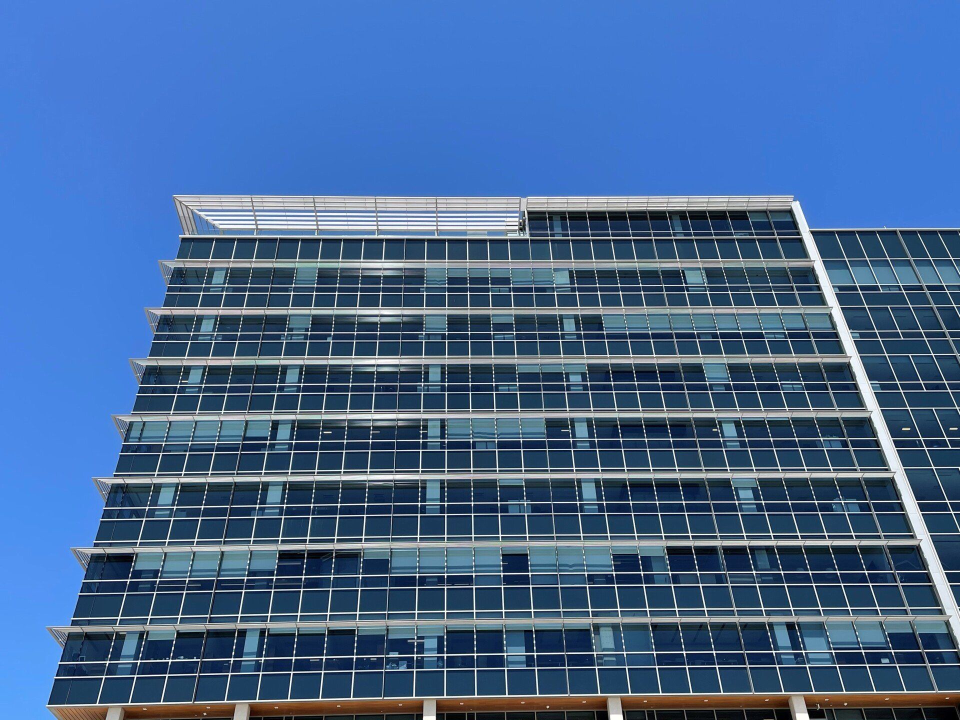Looking up at a tall building with a blue sky in the background