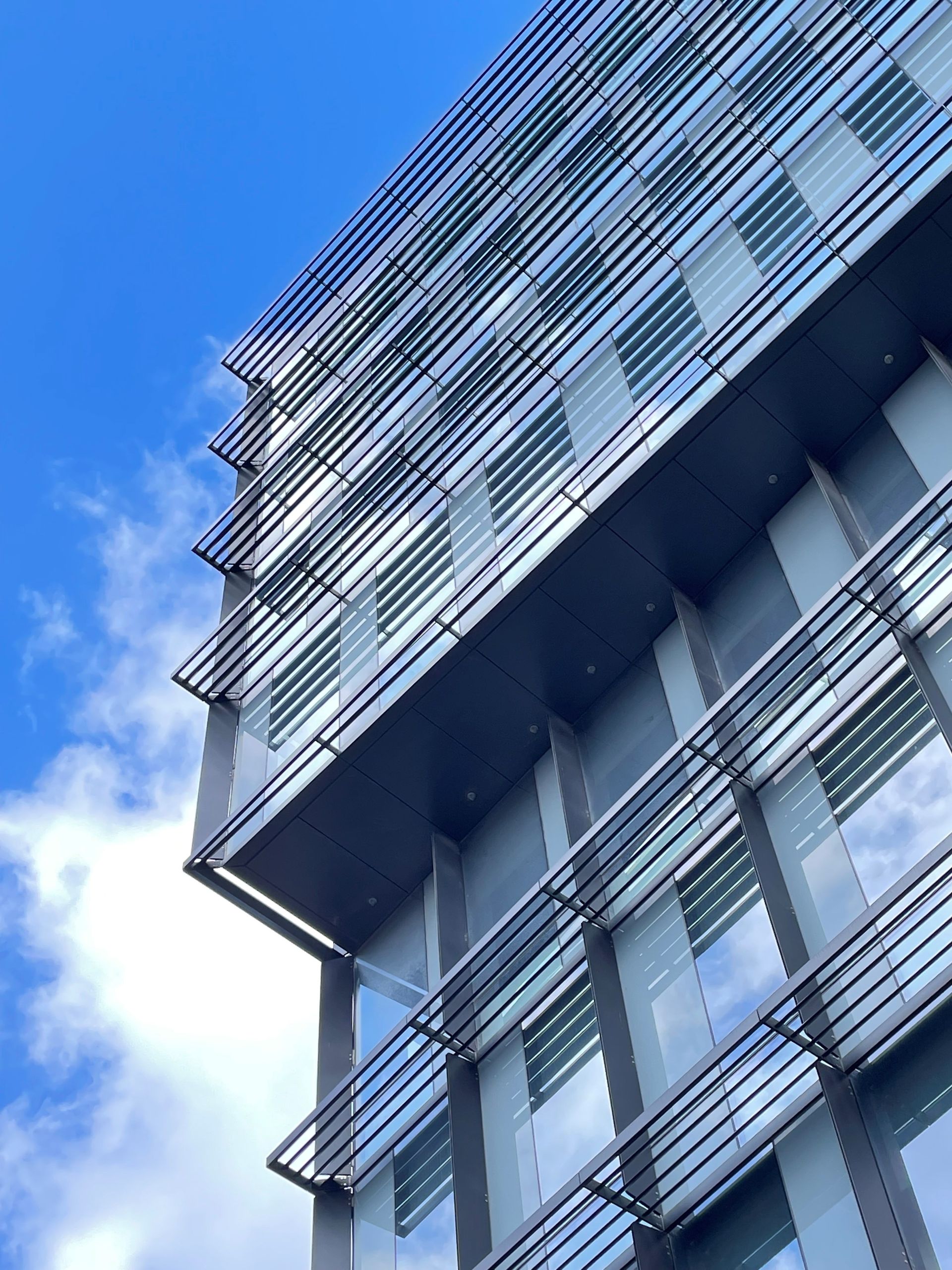 Looking up at a tall building with a blue sky in the background