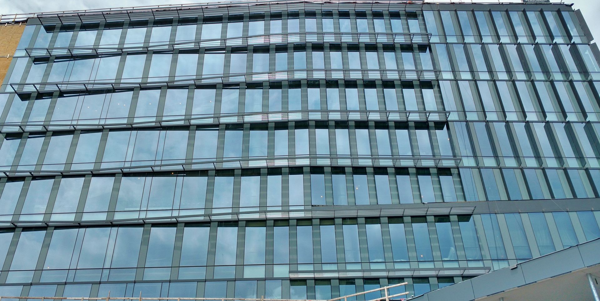 A large building with a lot of windows is being built