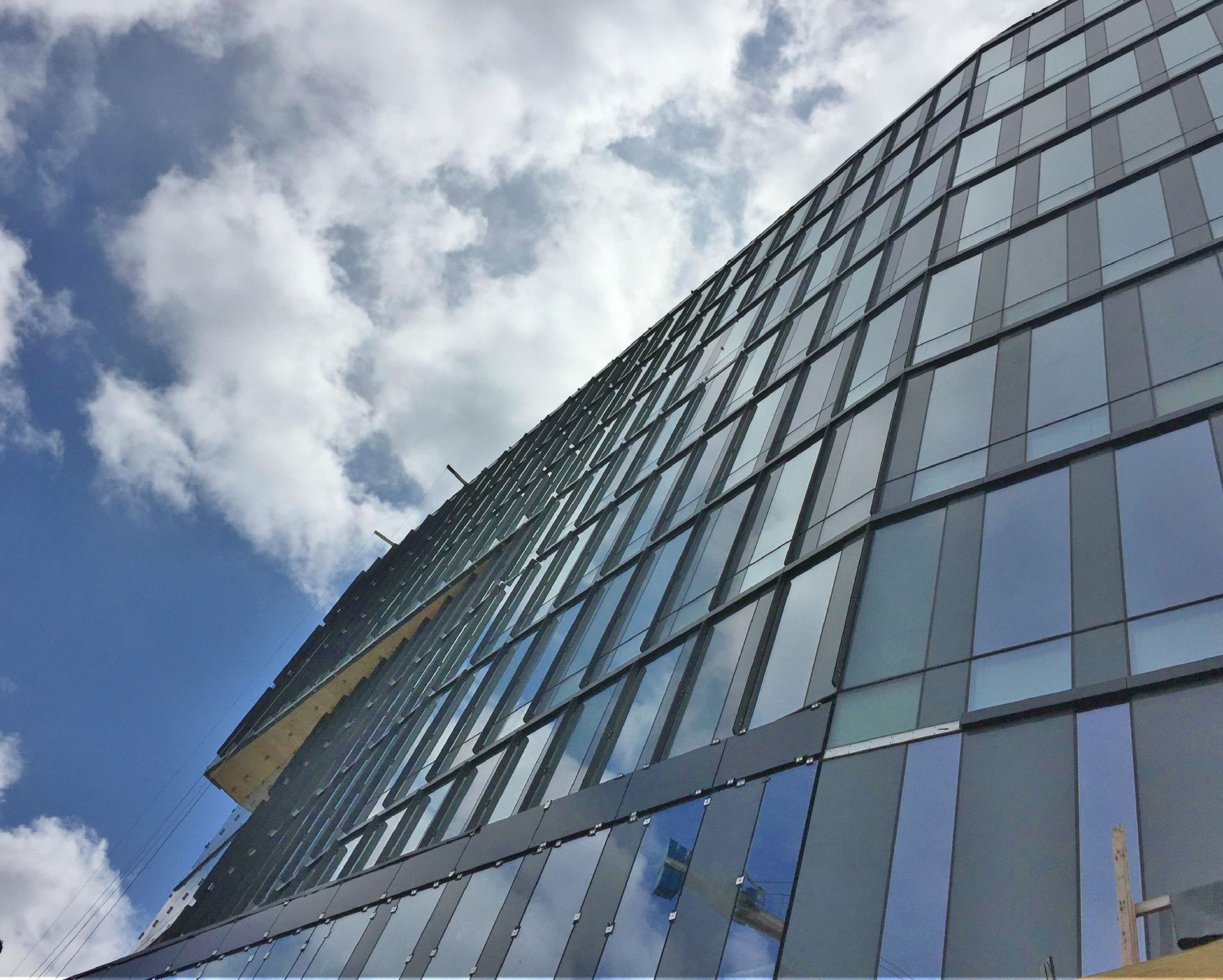Looking up at a tall building with a blue sky in the background