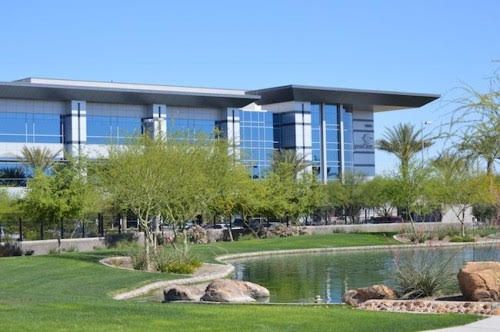 A large building with a pond in front of it