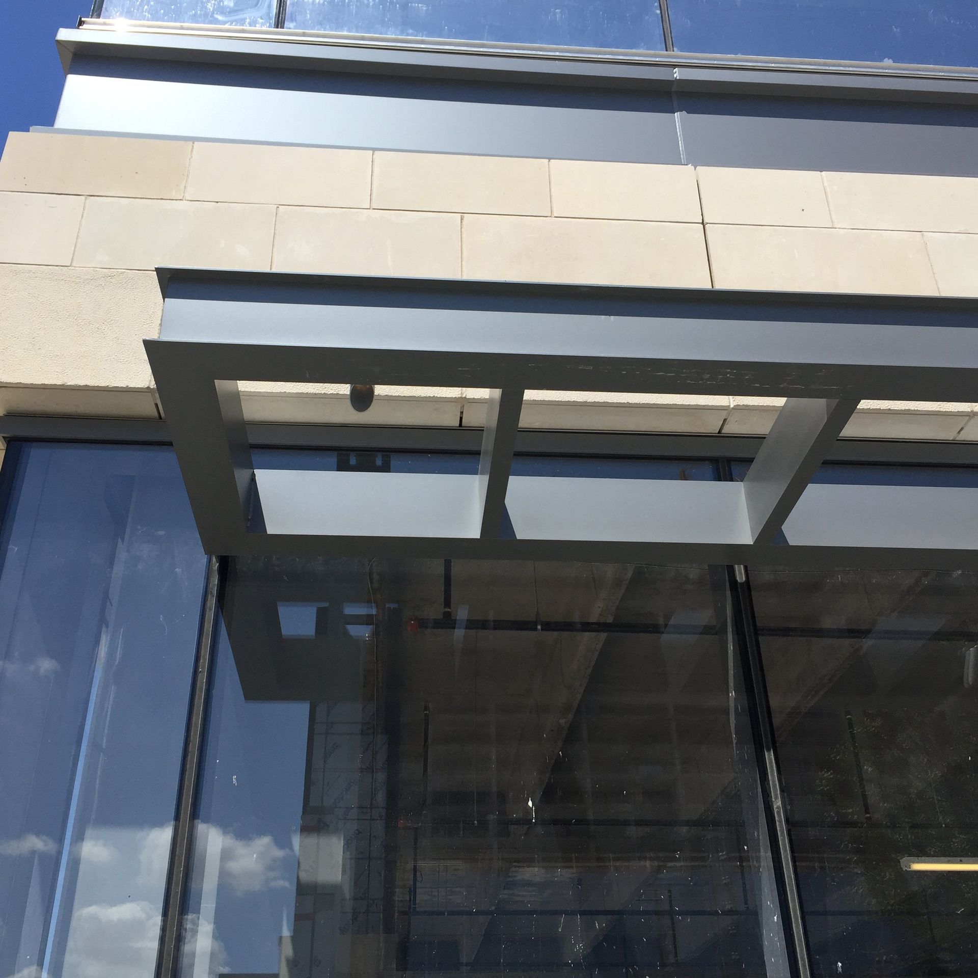 A building with a canopy over a glass door