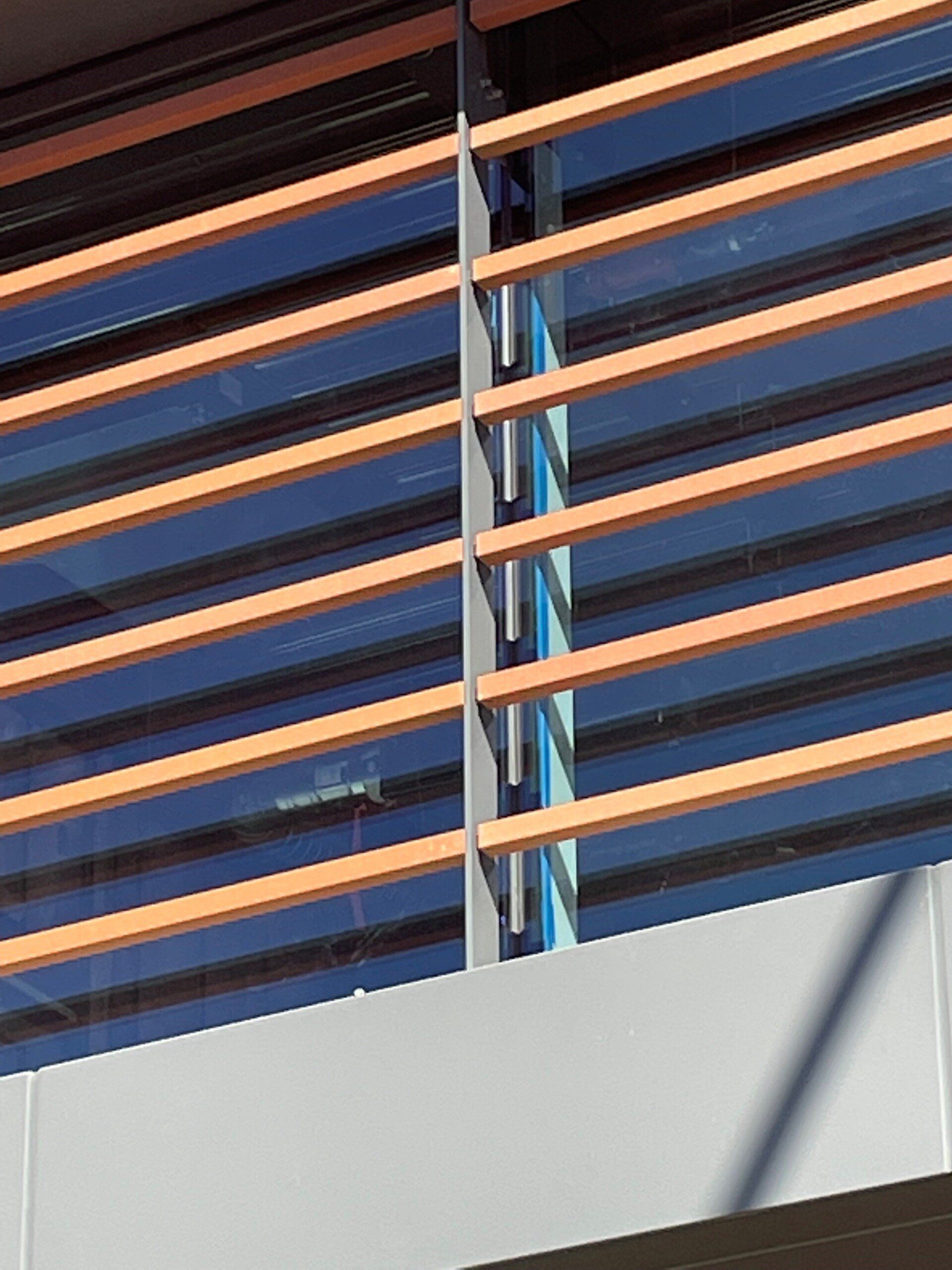 A building with a wooden railing and a blue sky in the background