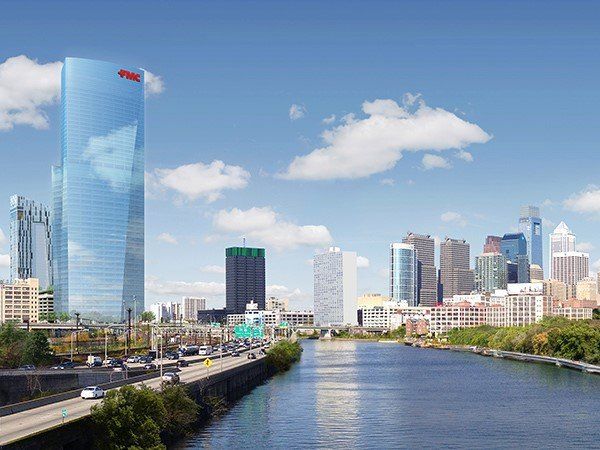 An artist 's impression of a city skyline with a river in the foreground.
