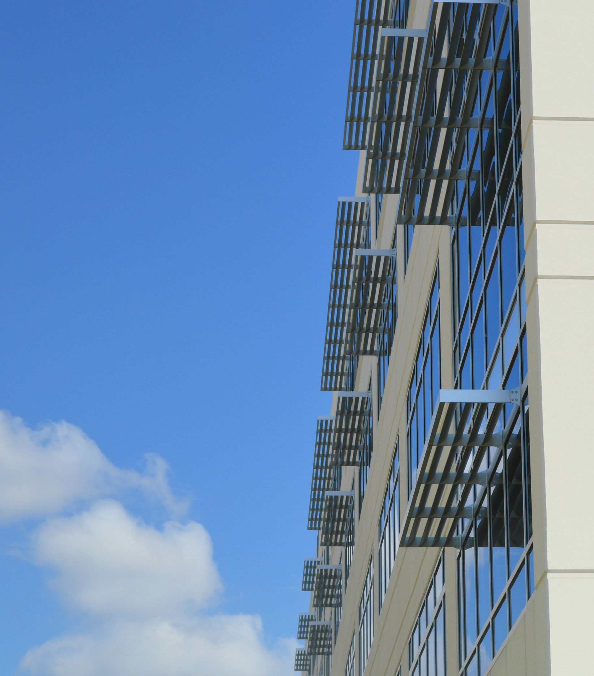 A building with a lot of windows against a blue sky