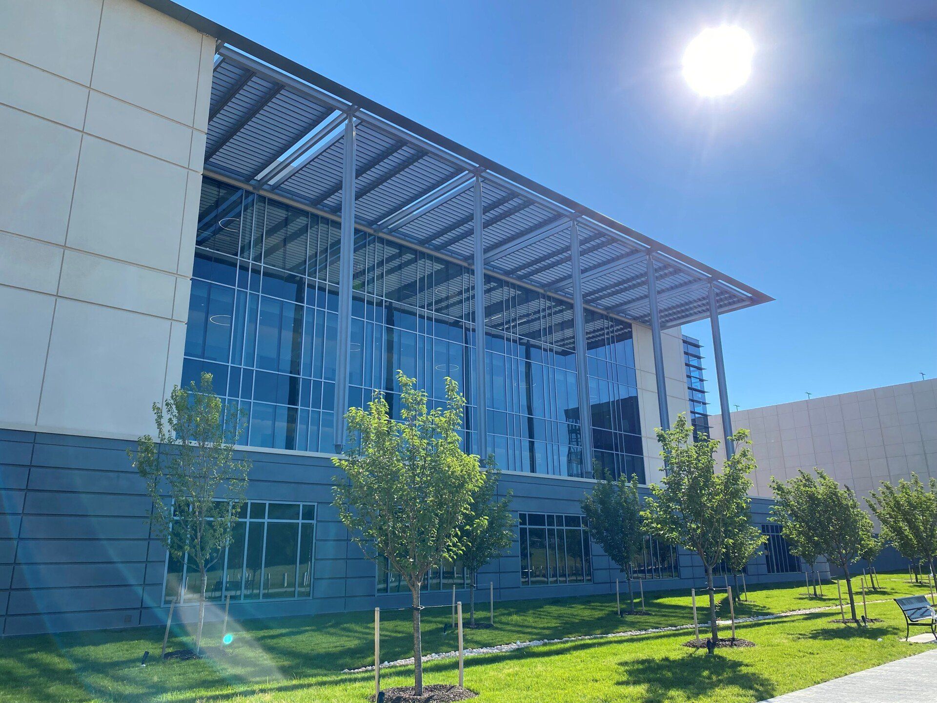 A large building with a lot of windows and trees in front of it