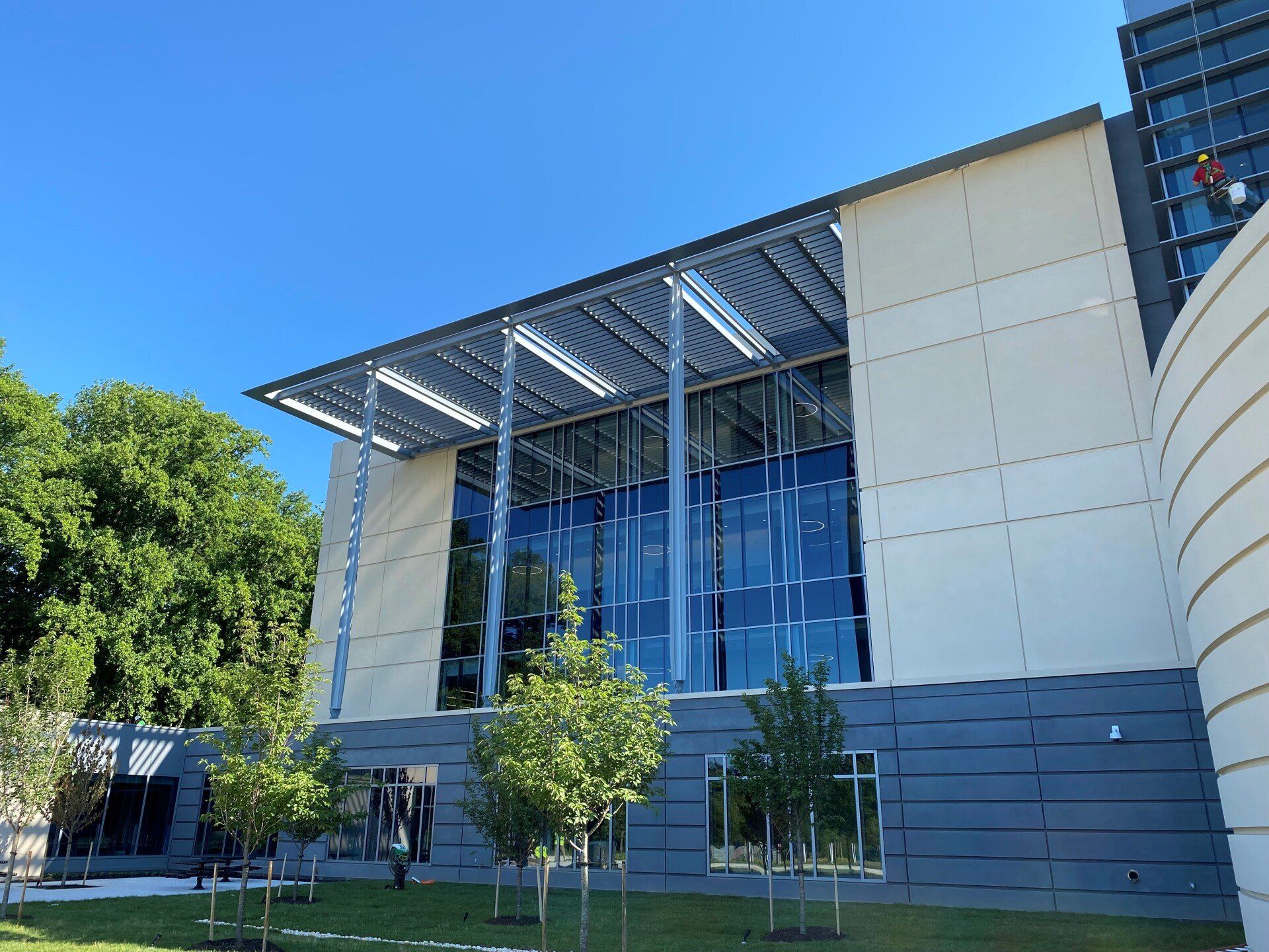 A large building with a lot of windows and trees in front of it