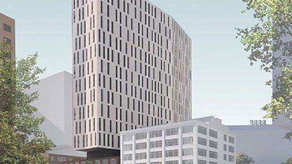 An artist 's impression of a tall building in a city.