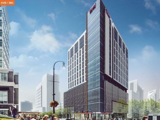 An artist 's impression of a tall building in a city