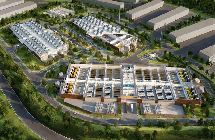 An aerial view of a large building surrounded by trees and buildings.