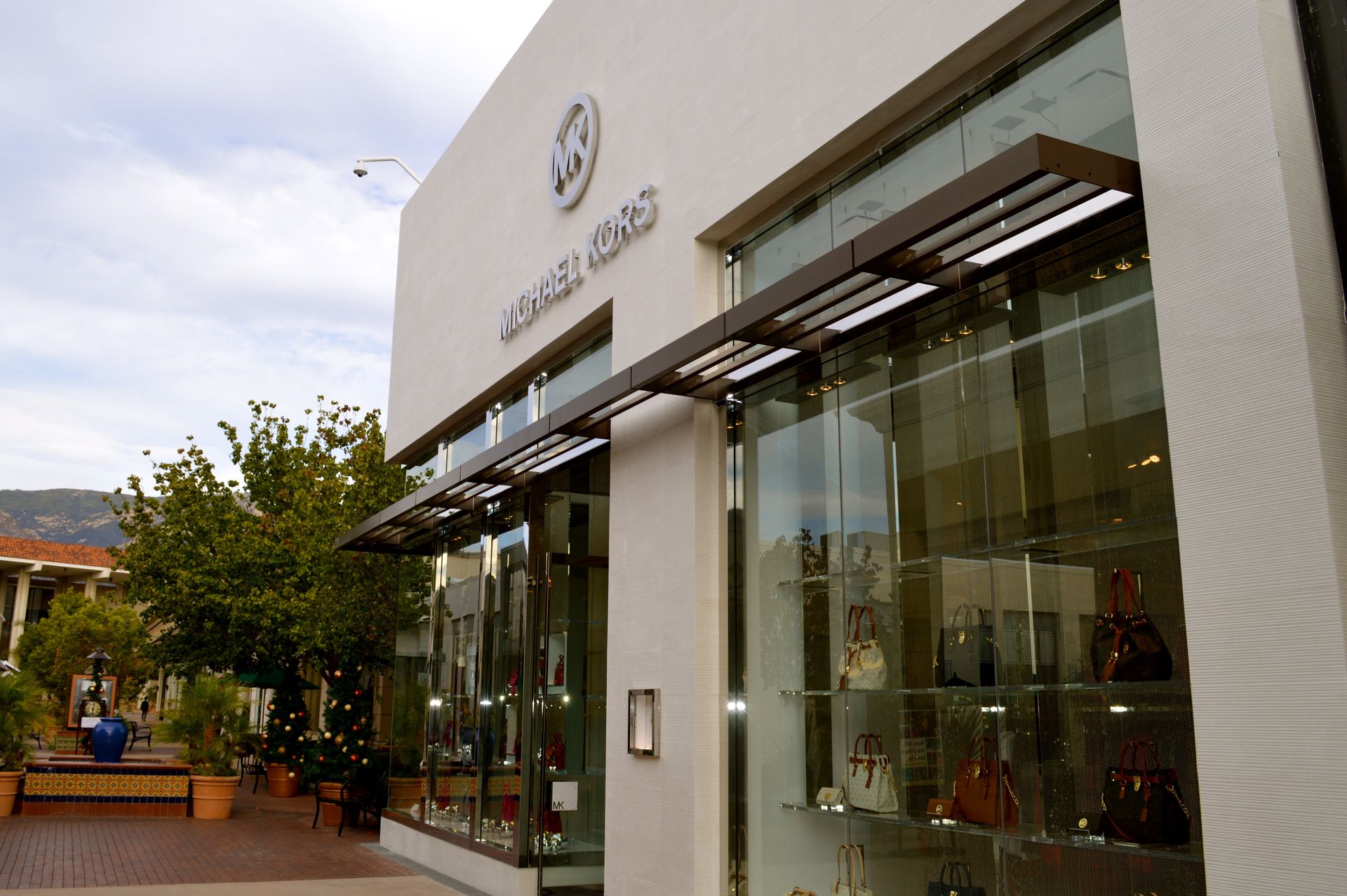 A michael kors store with lots of handbags on display