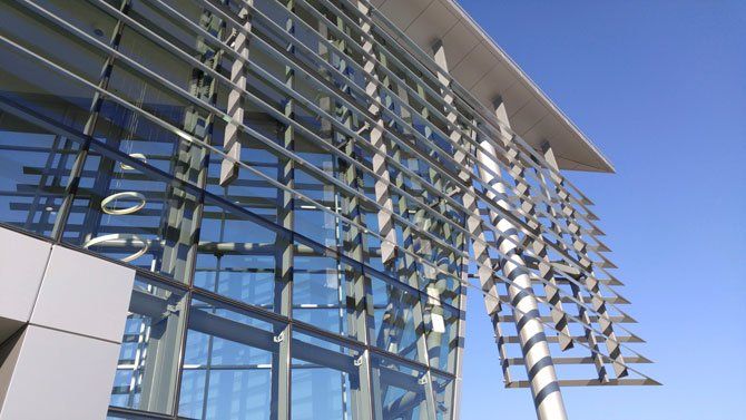 A building with a lot of windows and a blue sky in the background