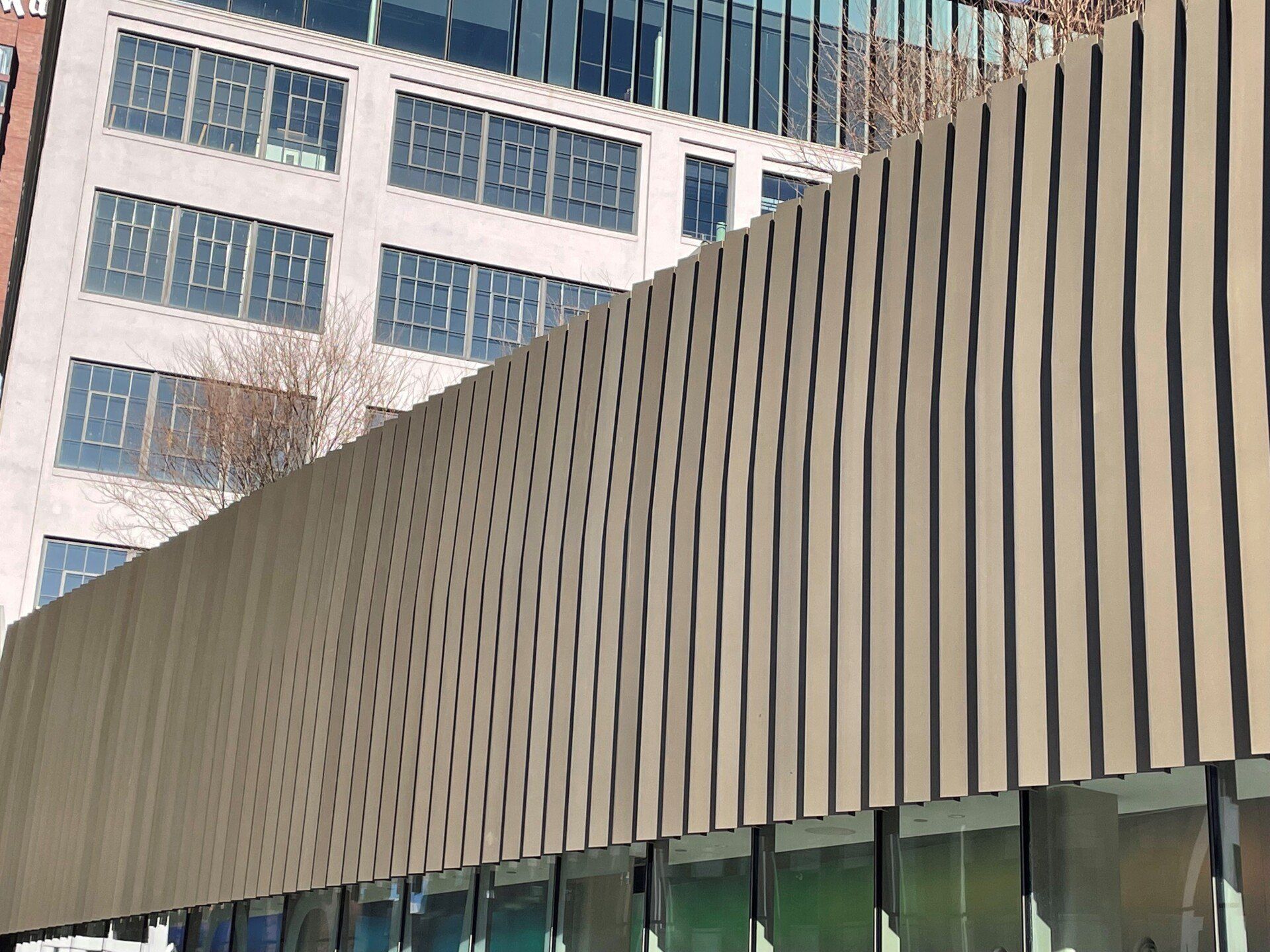 A building with a lot of windows and a fence in front of it.
