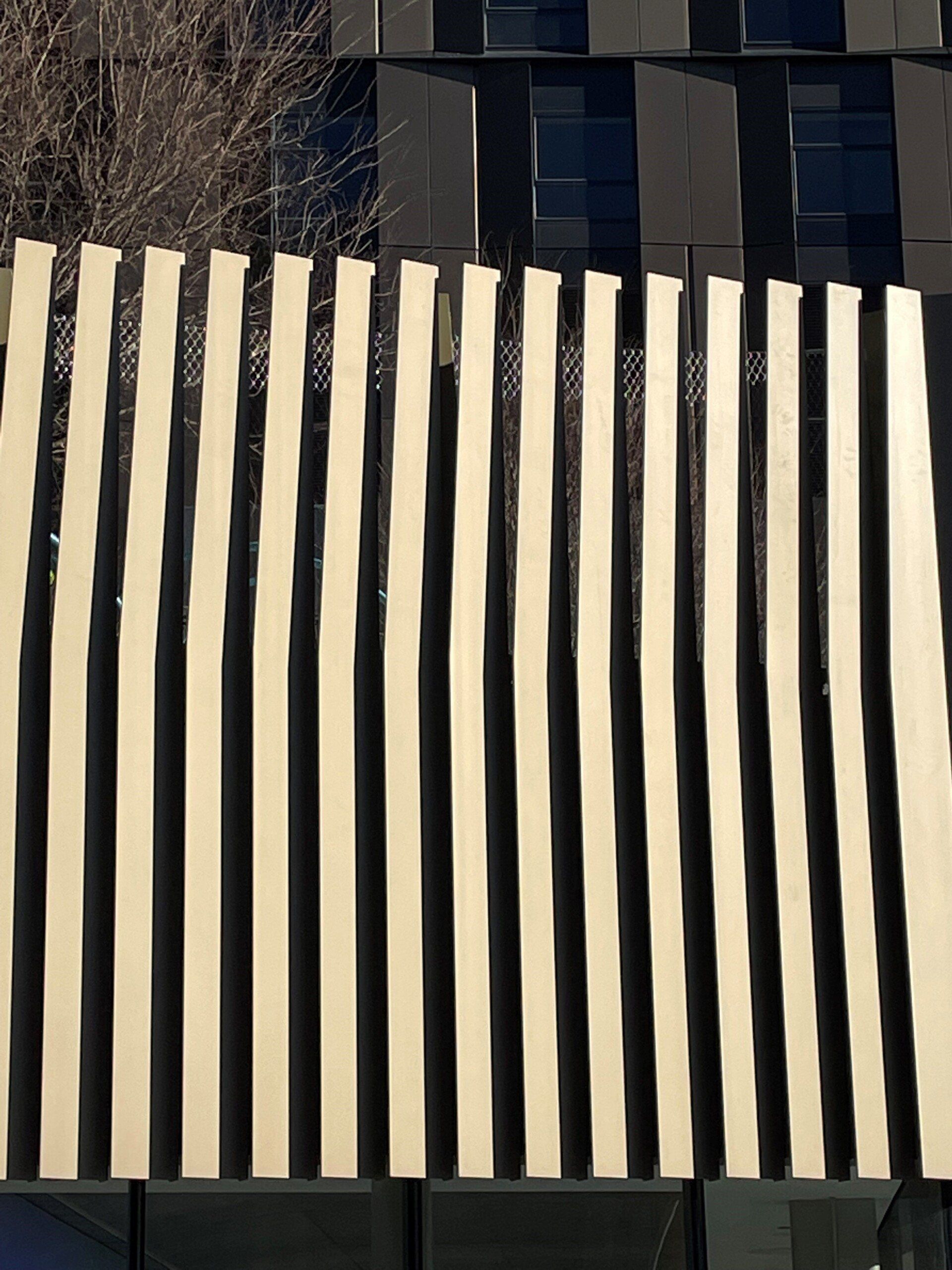 A building with a striped fence on the side of it
