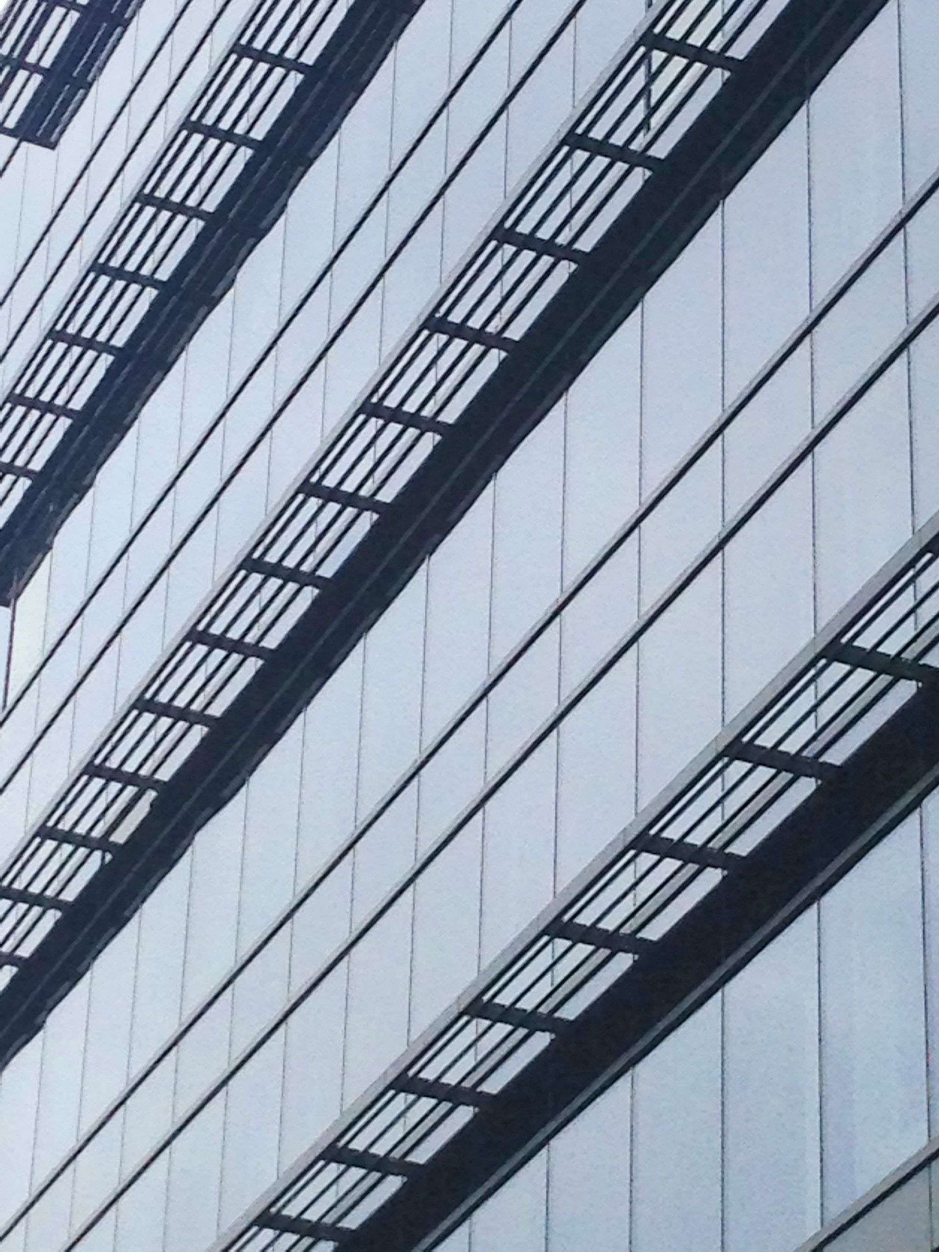 A tall building with a lot of windows and stairs