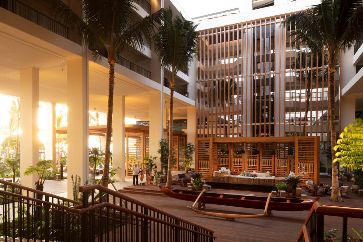 A large building with a lot of windows and palm trees