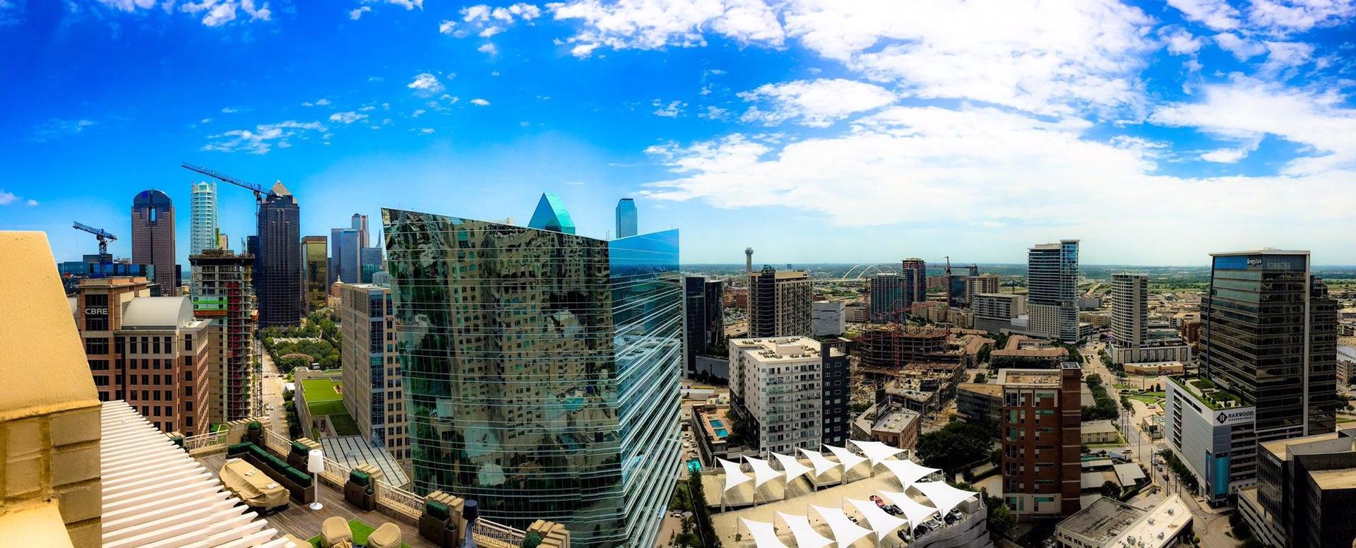 An aerial view of a city skyline on a sunny day.