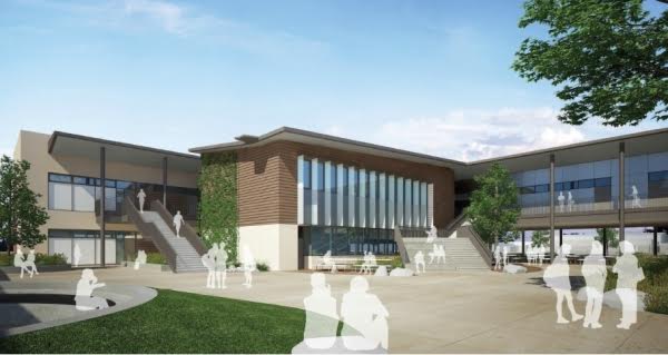 A group of people are standing in front of a large building.