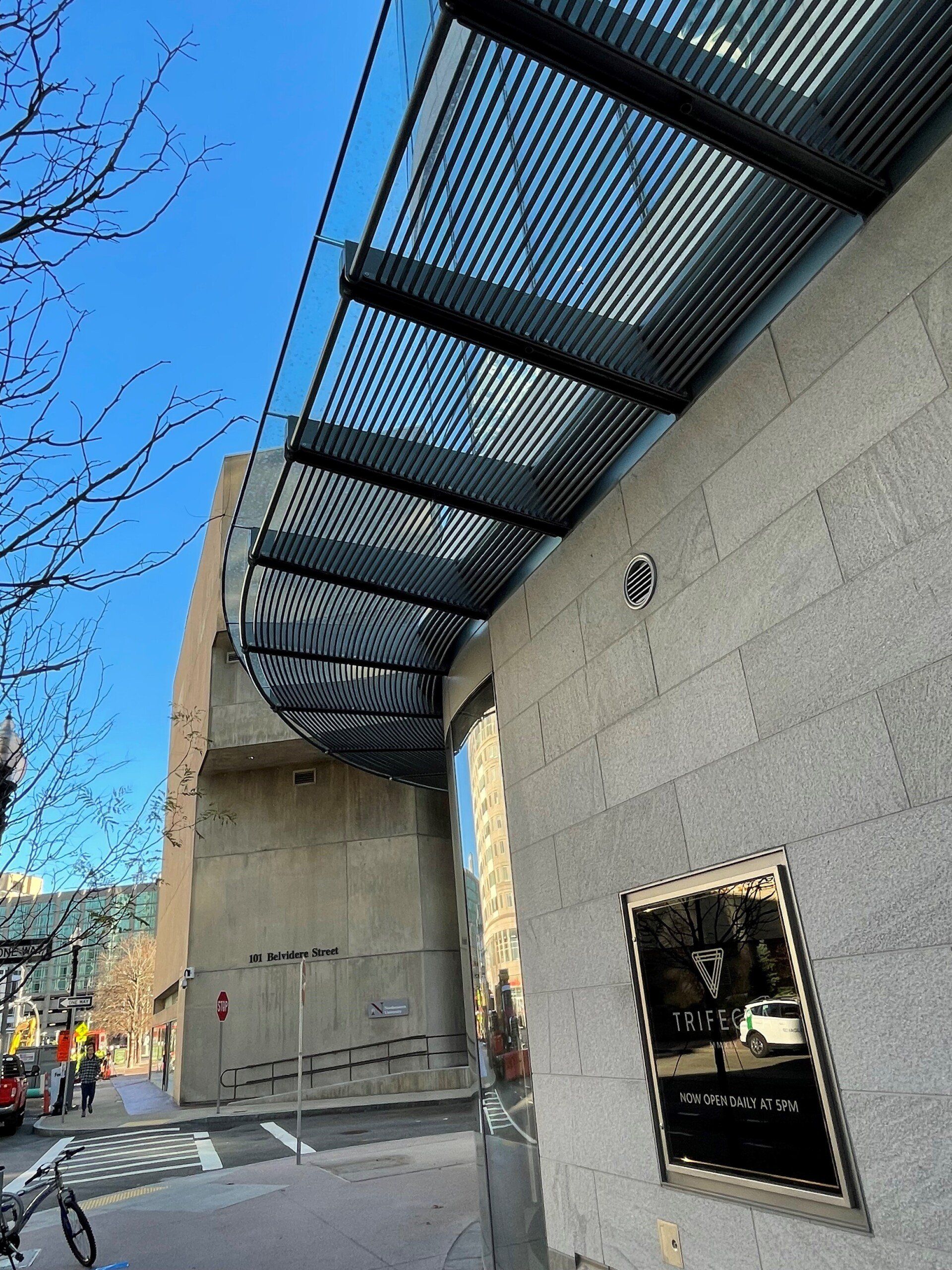 A building with a canopy and a sign that says triton