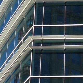 A building with a lot of windows and a blue sky in the background