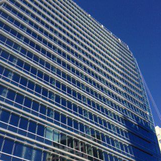 Looking up at a tall building with lots of windows