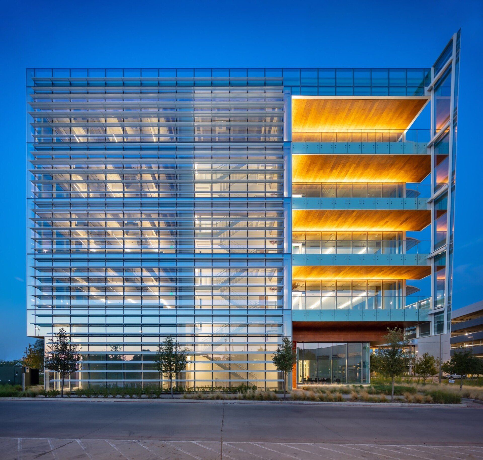 A large building with a lot of windows is lit up at night