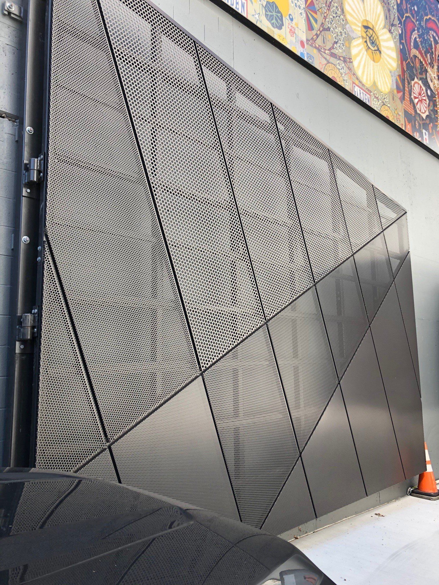 A metal wall with a geometric pattern on it