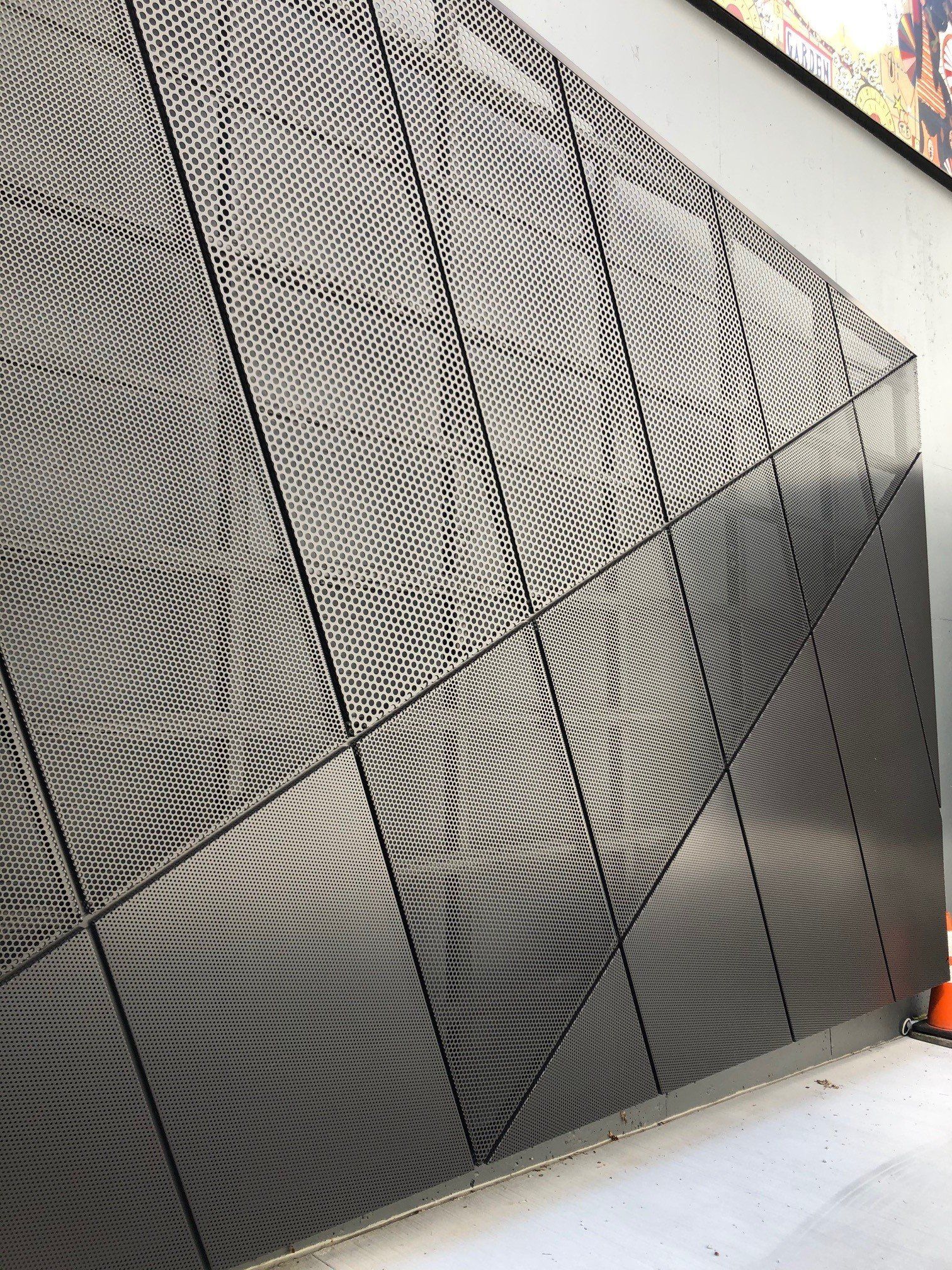 A metal wall with a geometric pattern on it