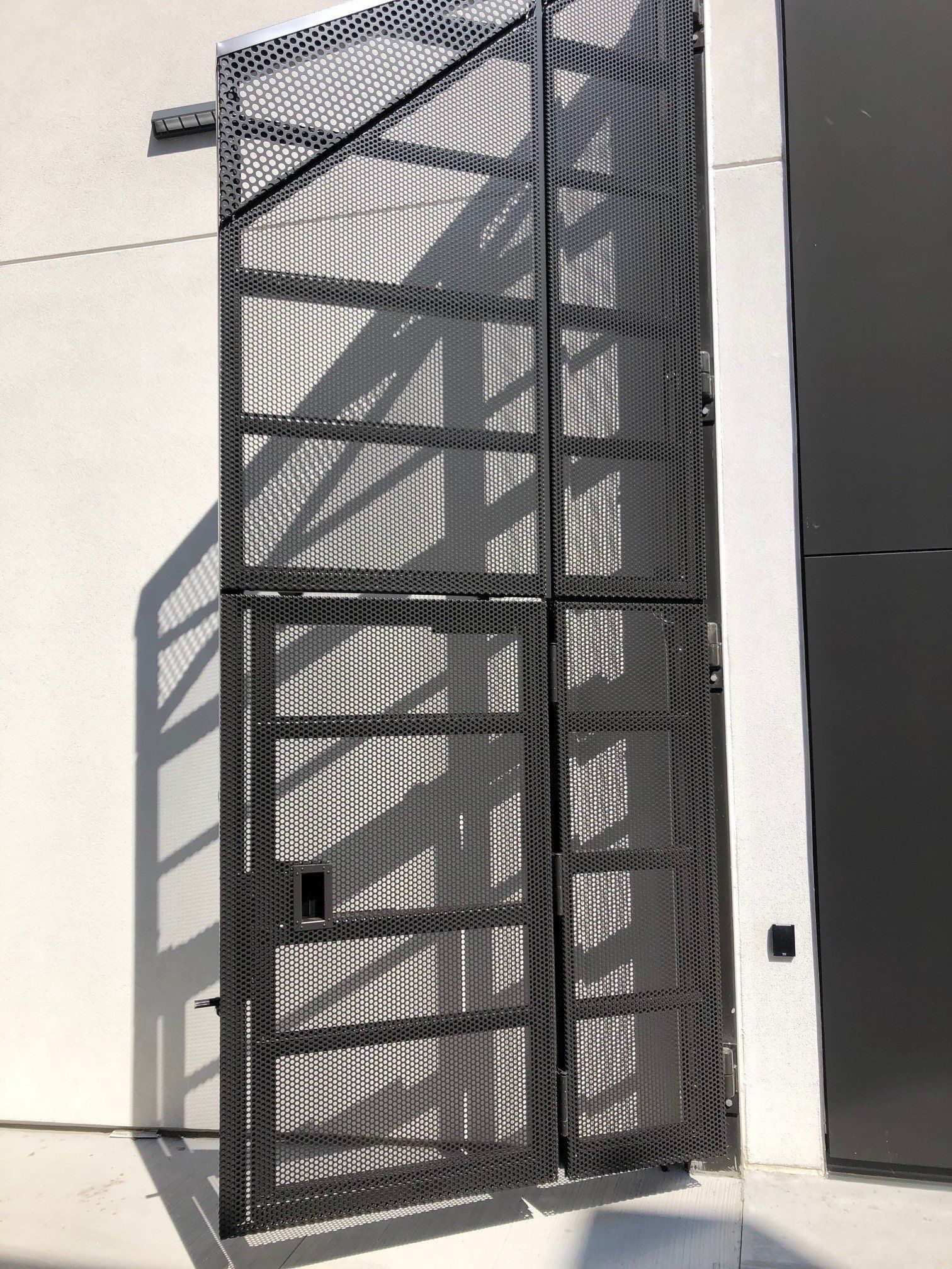 A metal gate with a staircase behind it