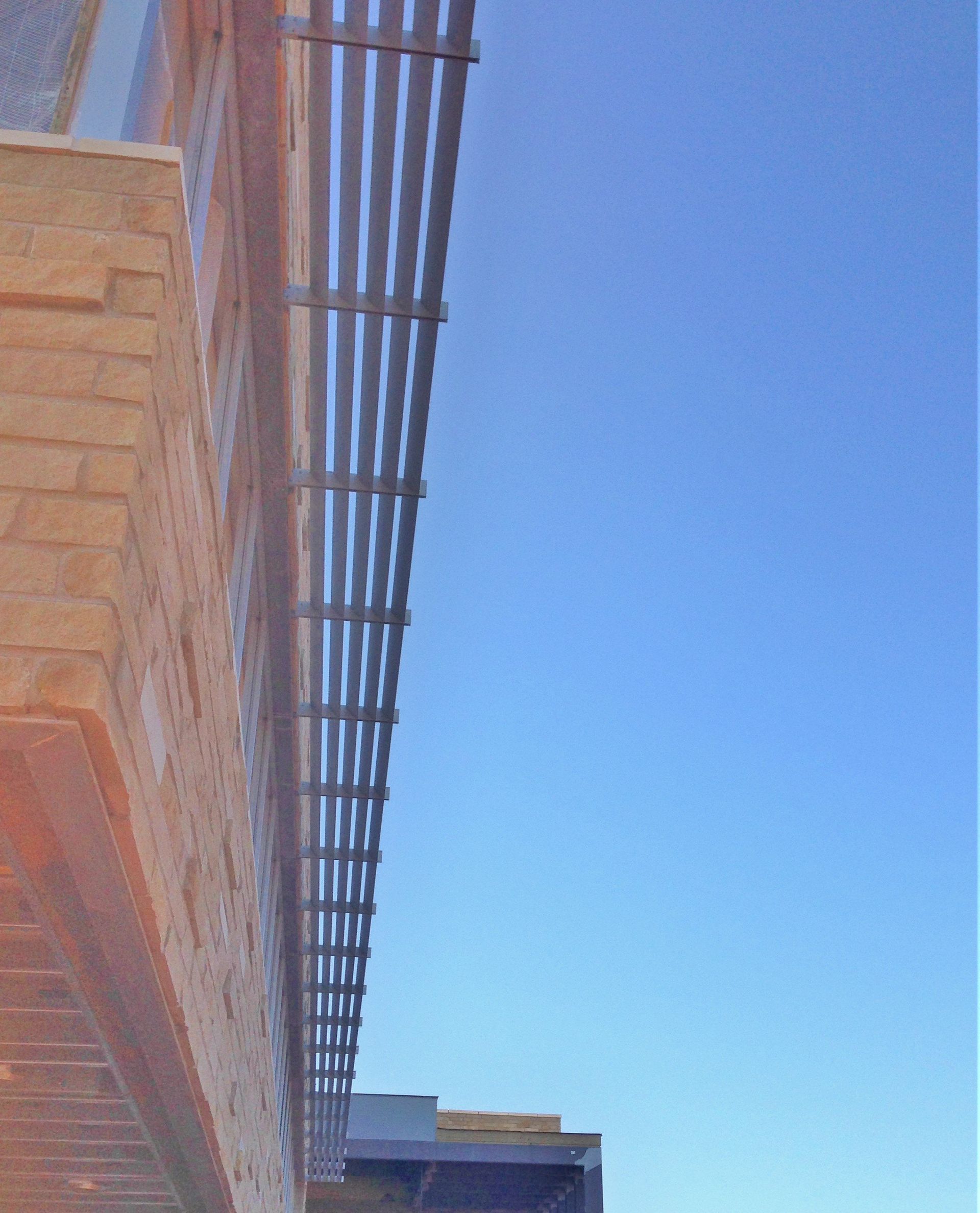 Looking up at a building with a blue sky in the background