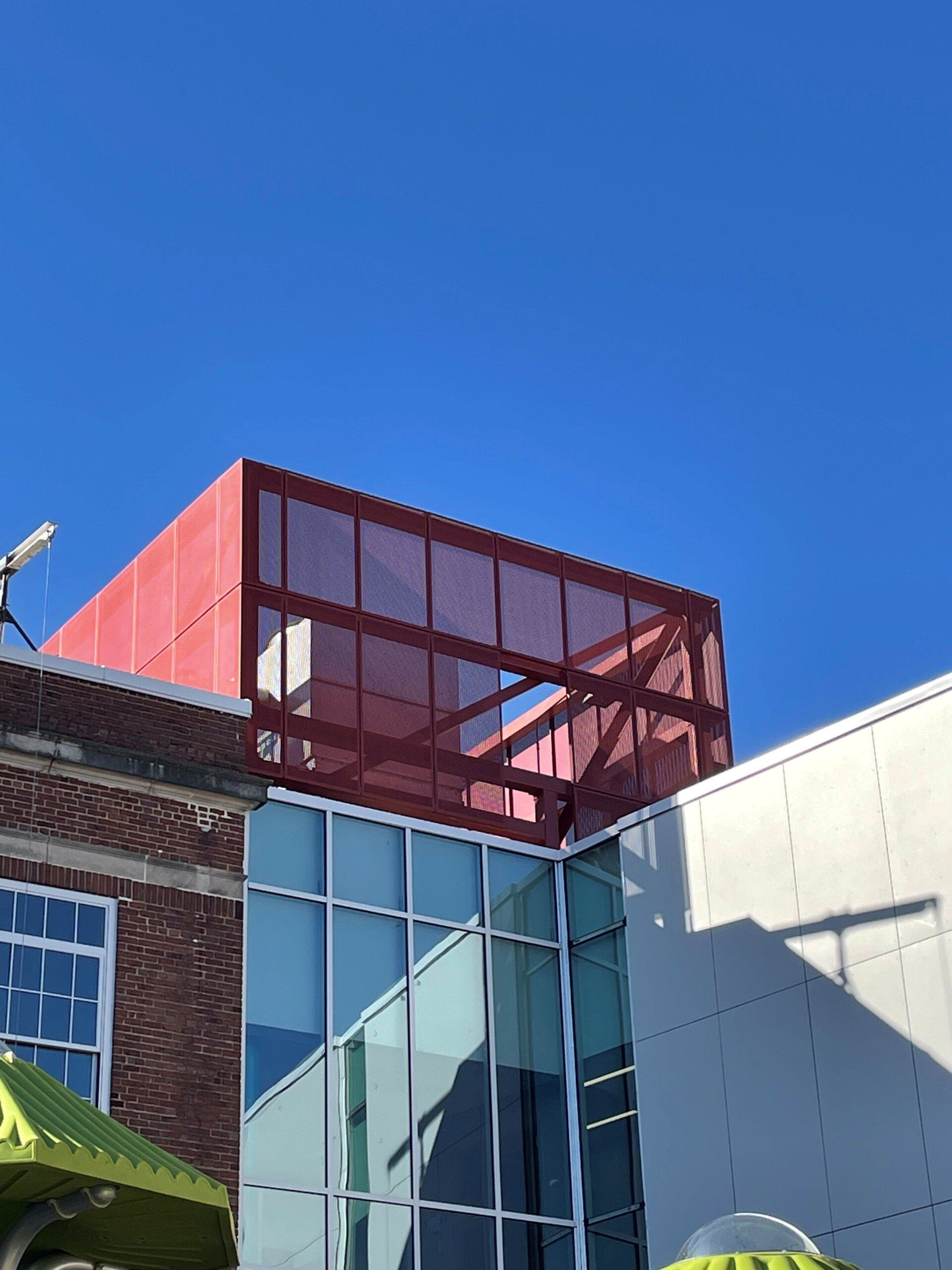 A building with a red roof and a blue sky in the background