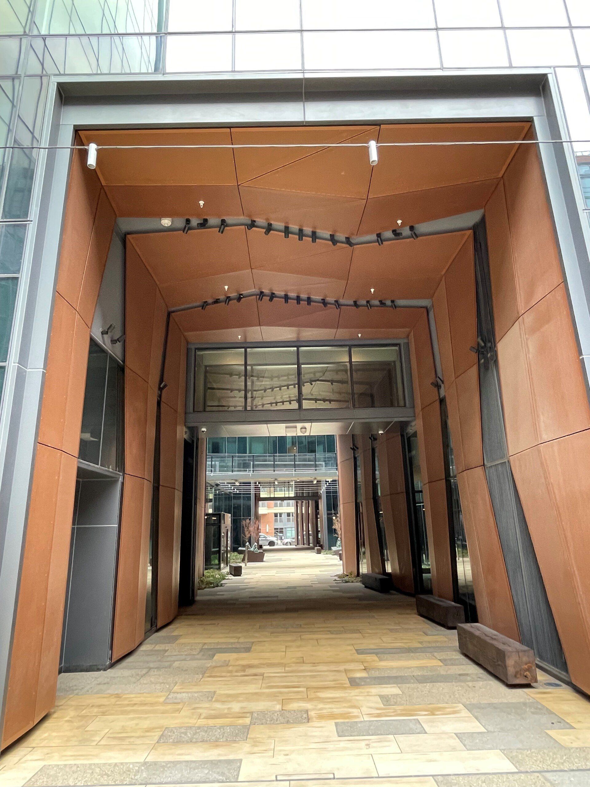 A large building with a wooden archway leading to it