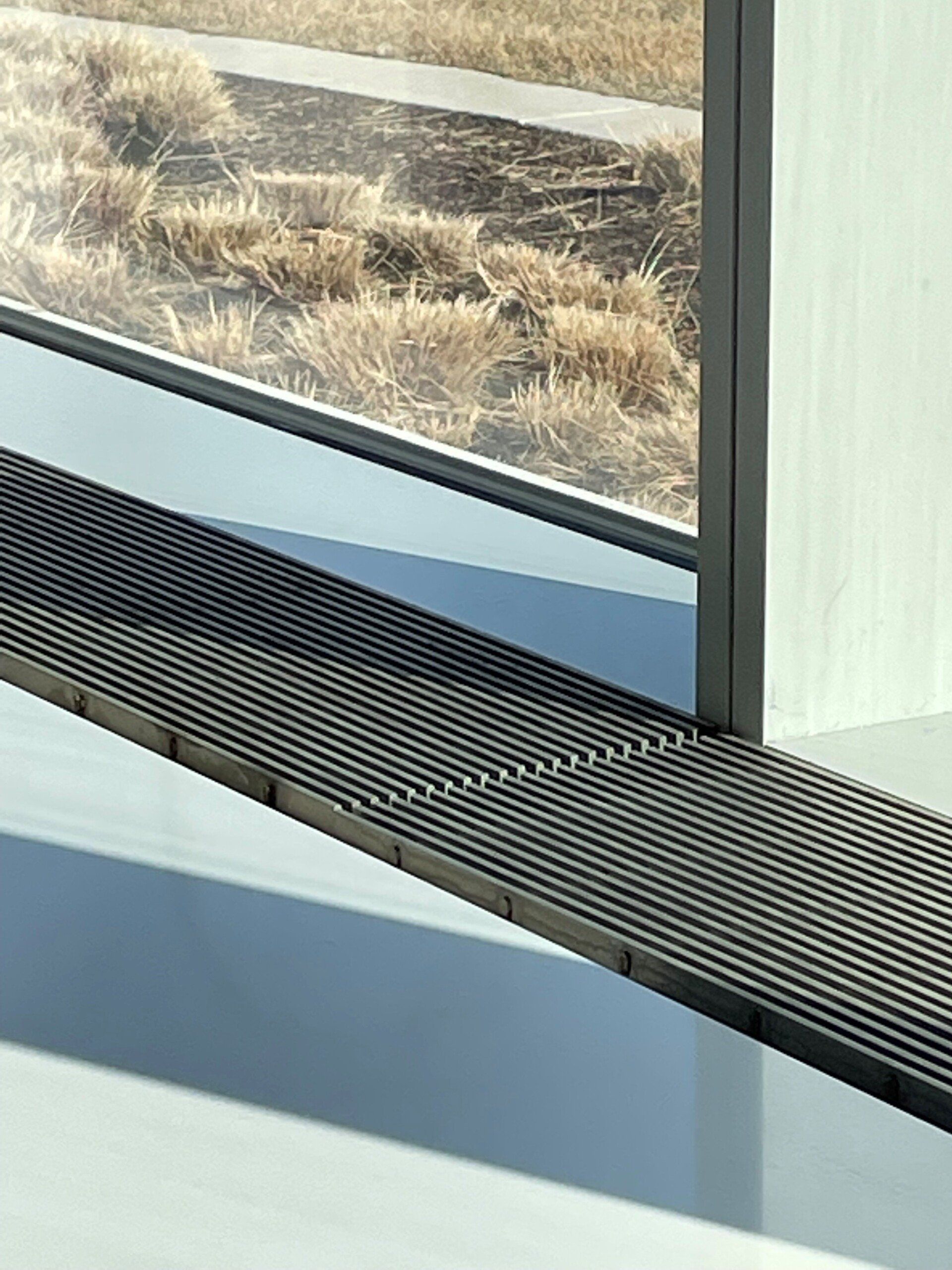 A window with a metal grate on the side of it