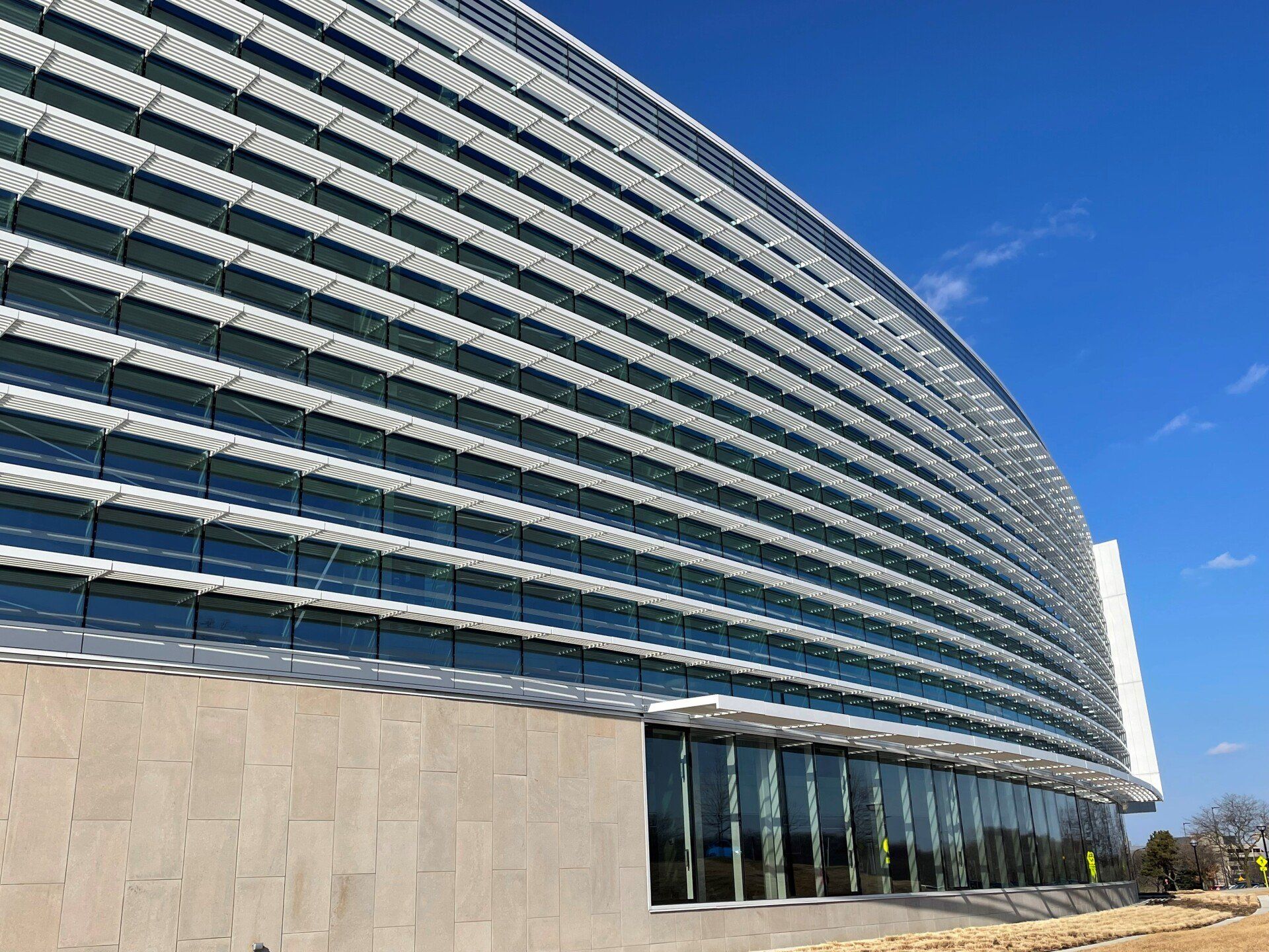 A large building with a lot of windows and a blue sky in the background