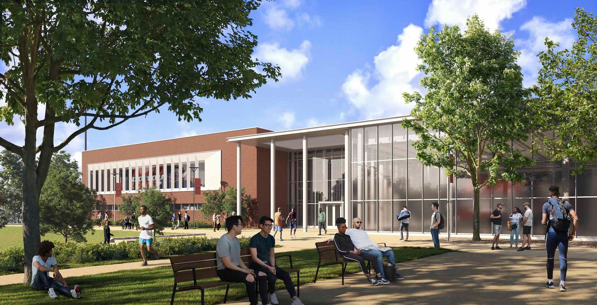 A group of people are sitting on benches in front of a large building.