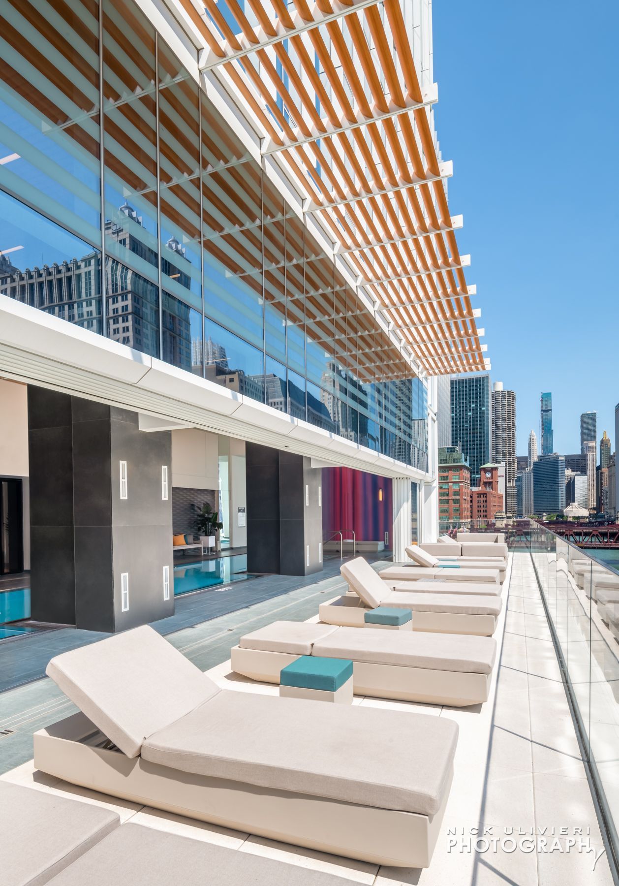 A row of lounge chairs on the side of a building