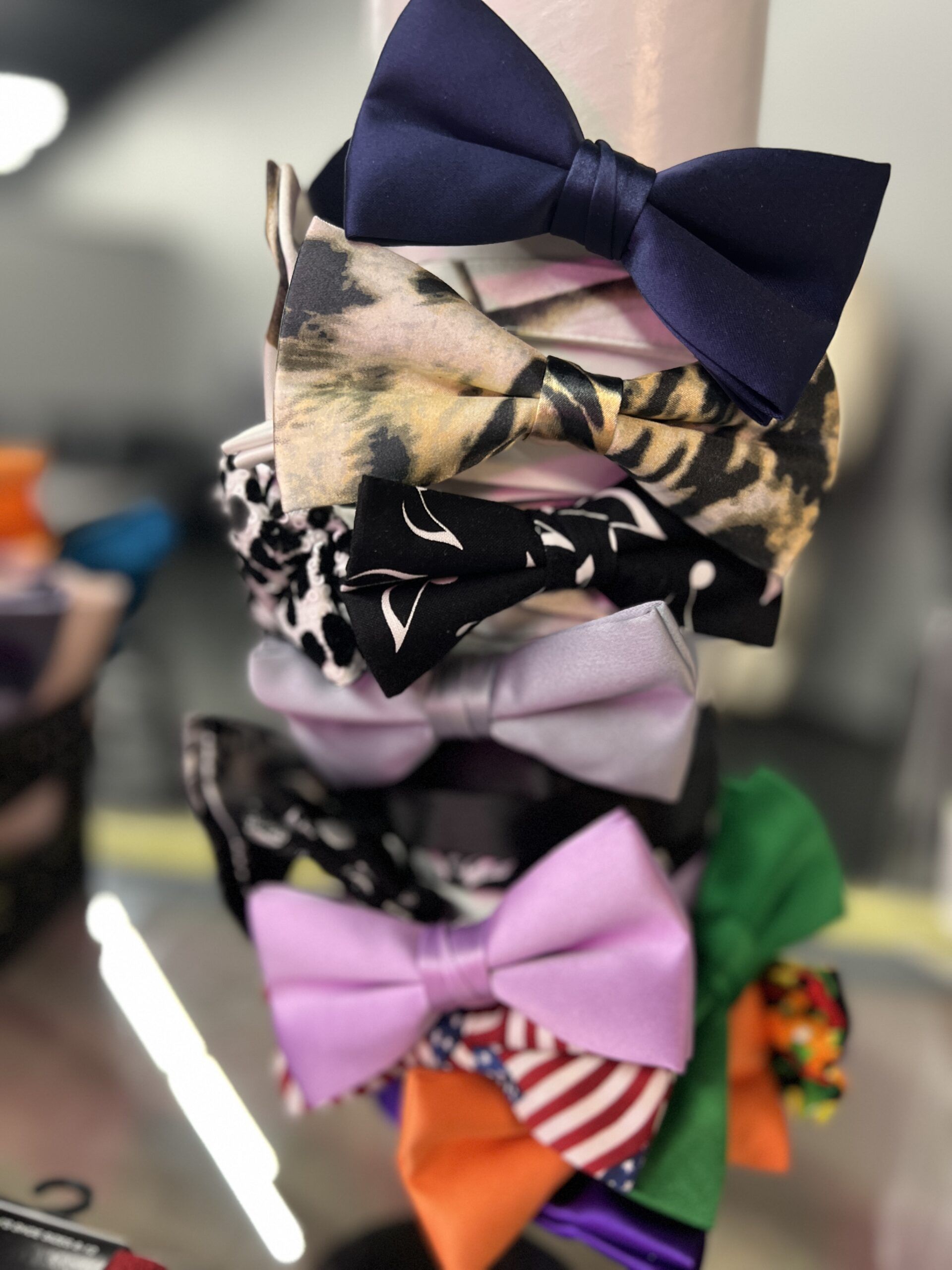 Stack of colorful bow headbands, including leopard print, solid colors, and patterned designs.