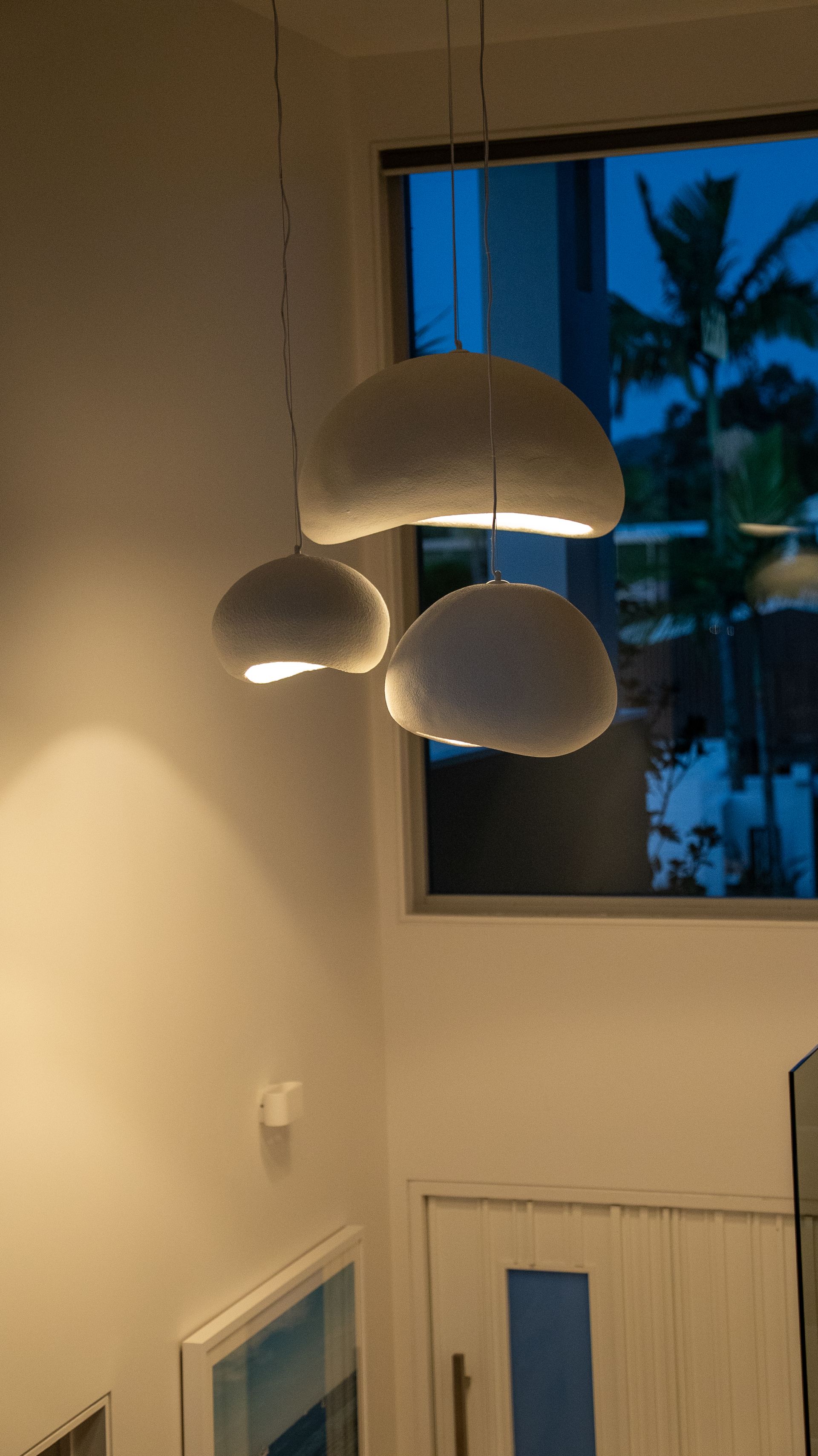 Modern Room With Hanging Pendant Lights Beside a Window — Ralph Ottmann Electrical in Sunshine Beach, QLD