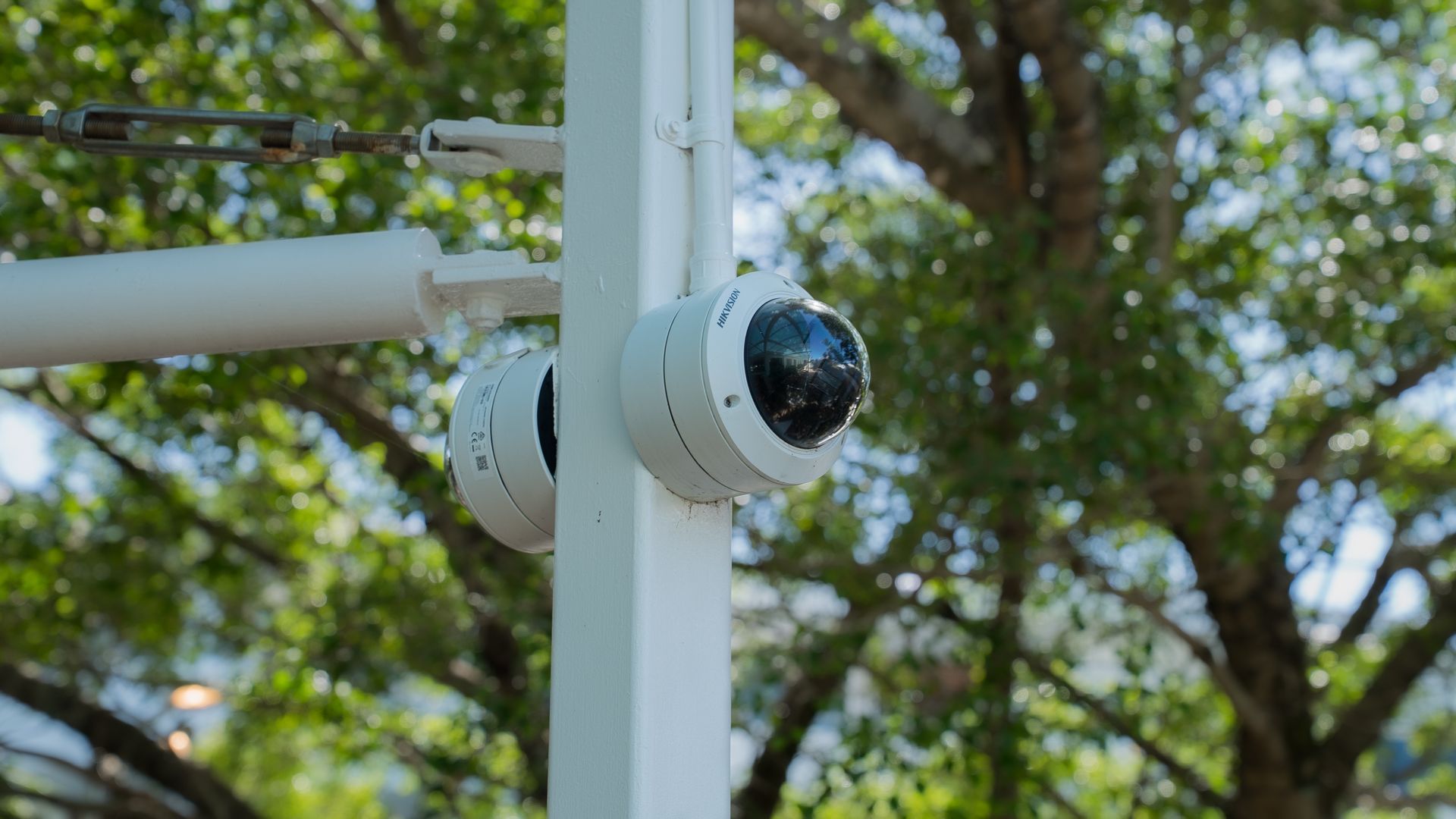 White Security Camera Mounted on a Pole Outdoors — Ralph Ottmann Electrical in Pomona, QLD