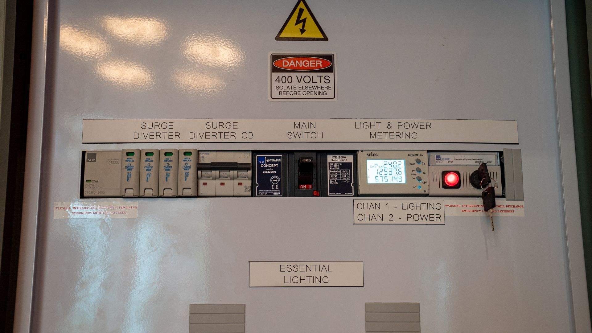 Electrical Control Panel with Warning Sign, Switches, and Digital Display Inside a Metal Cabinet — Ralph Ottmann Electrical in Pomona, QLD