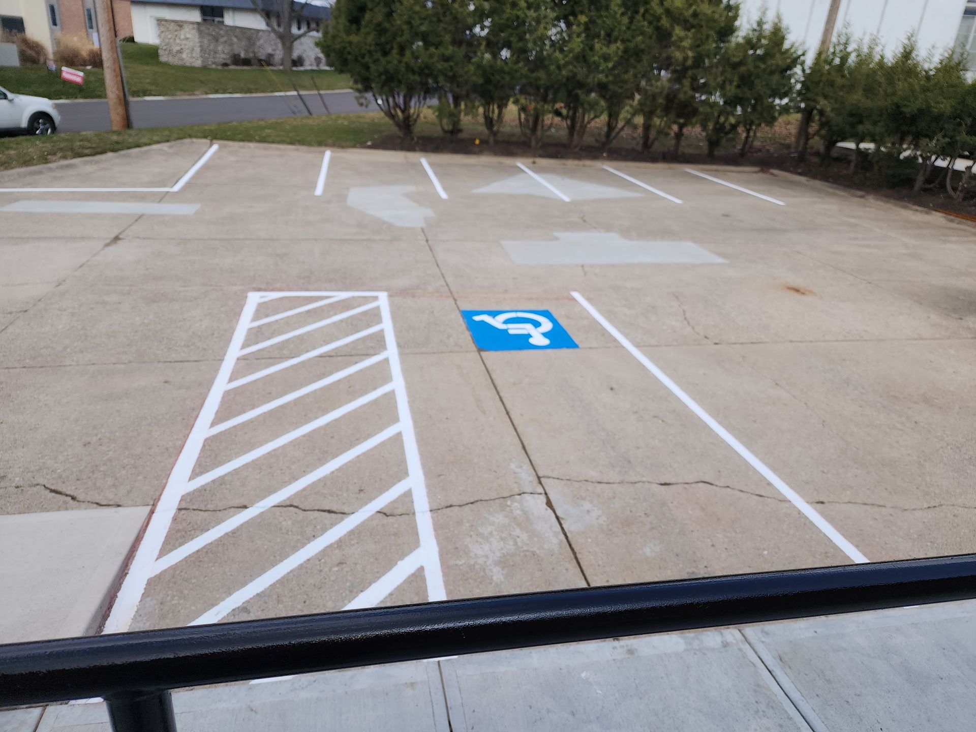 A parking lot with a handicap sign painted on the ground