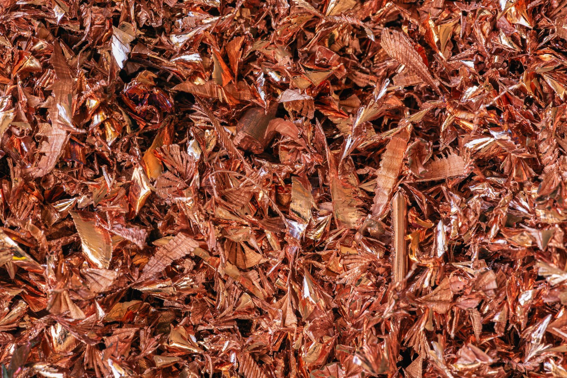 Piles of copper wire scraps at a recycling facility for non-ferrous metal recovery and reuse. Piles of copper wire scraps at a recycling facility for non-ferrous metal recovery and reuse.