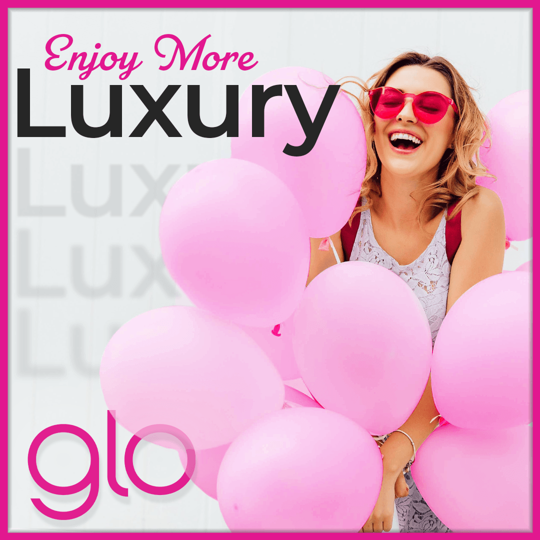 A woman wearing pink sunglasses is holding pink balloons.