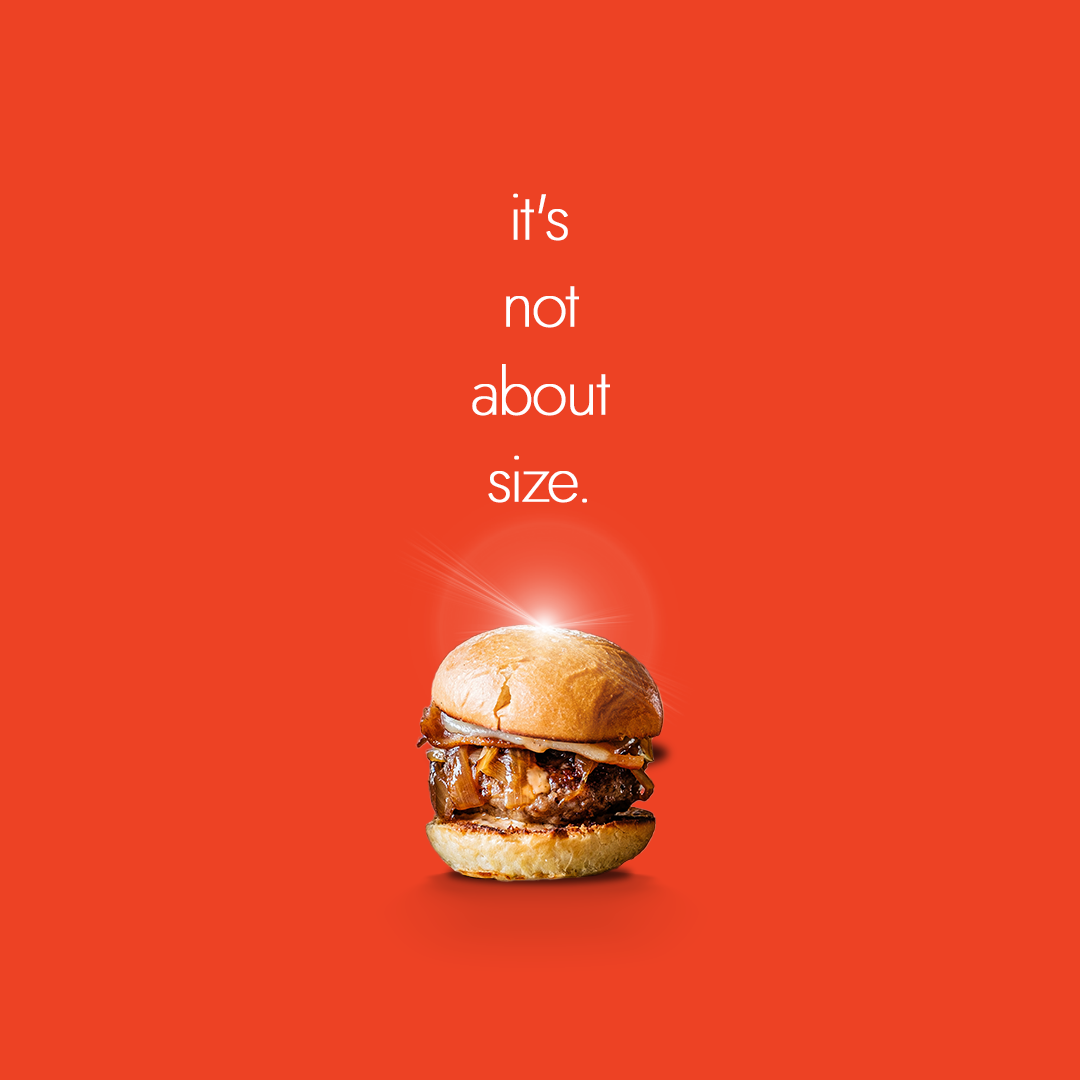 An advertisement for a tiny hamburger that says it 's not about size
