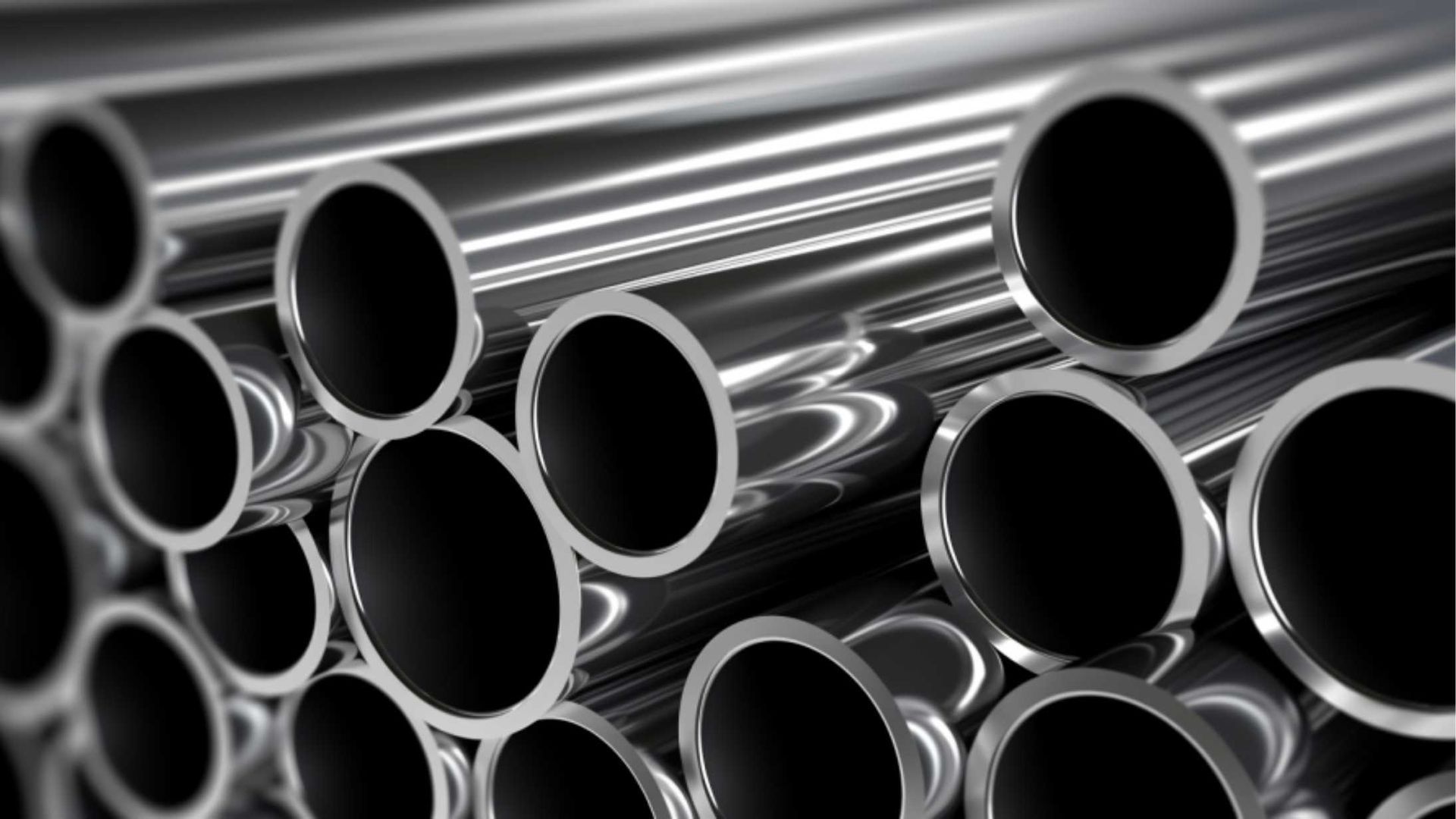 A bunch of metal pipes are stacked on top of each other.