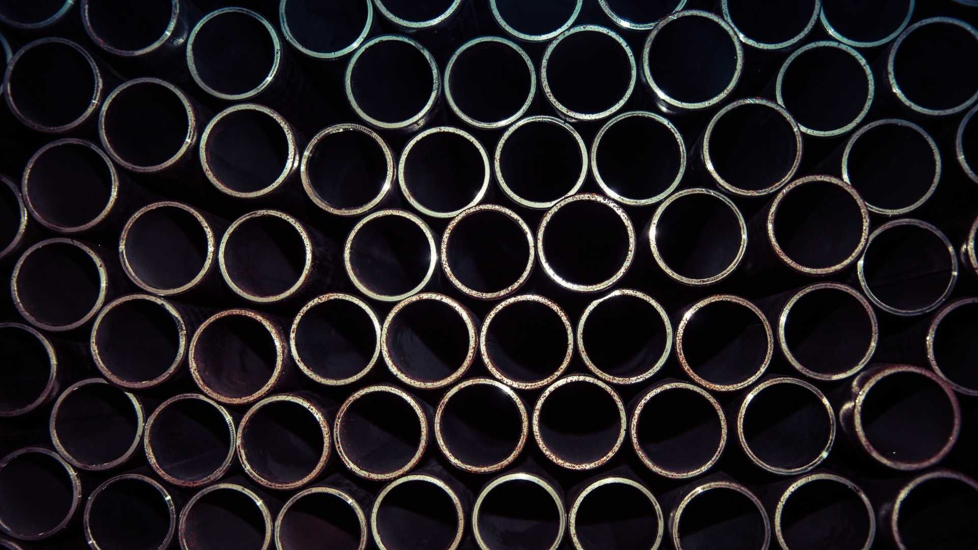 A bunch of metal pipes stacked on top of each other