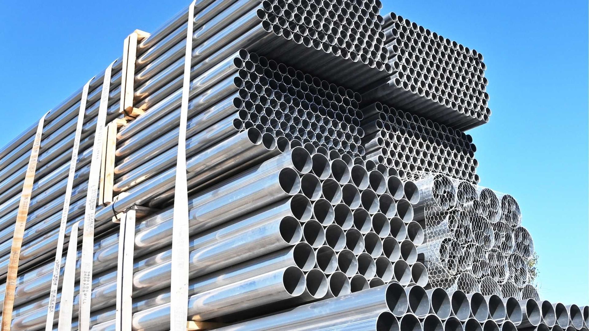 A stack of metal pipes against a blue sky