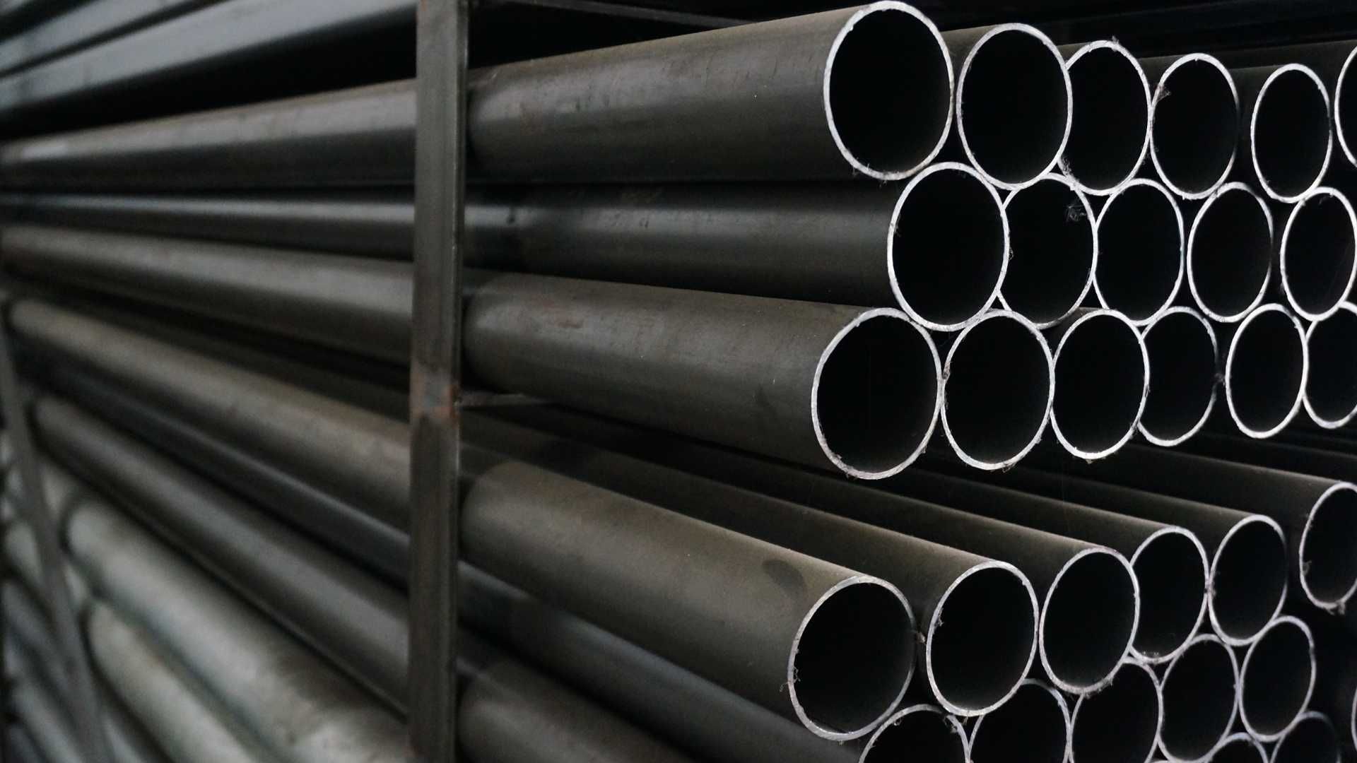 A bunch of metal pipes stacked on top of each other