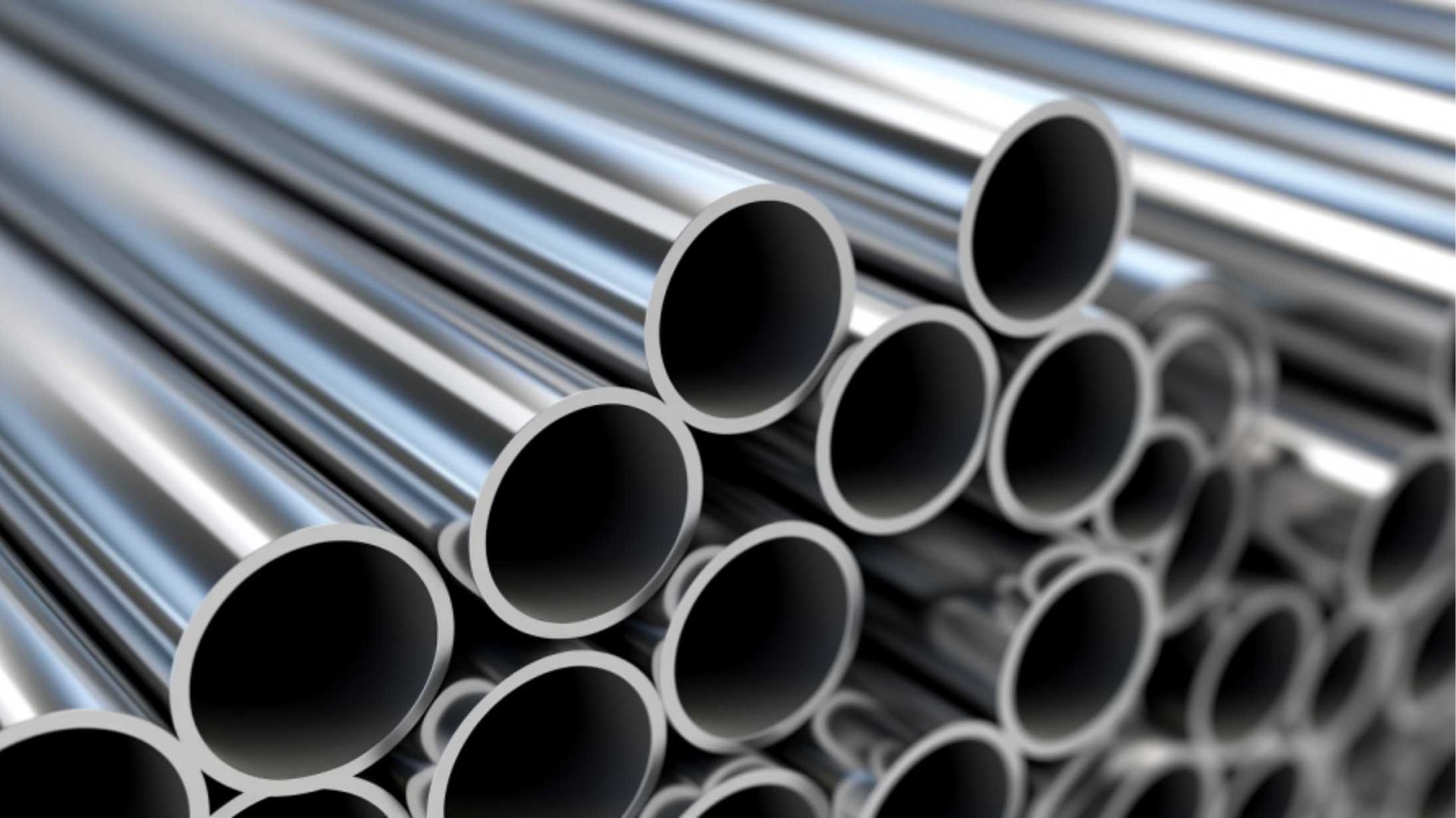 A bunch of metal pipes are stacked on top of each other.