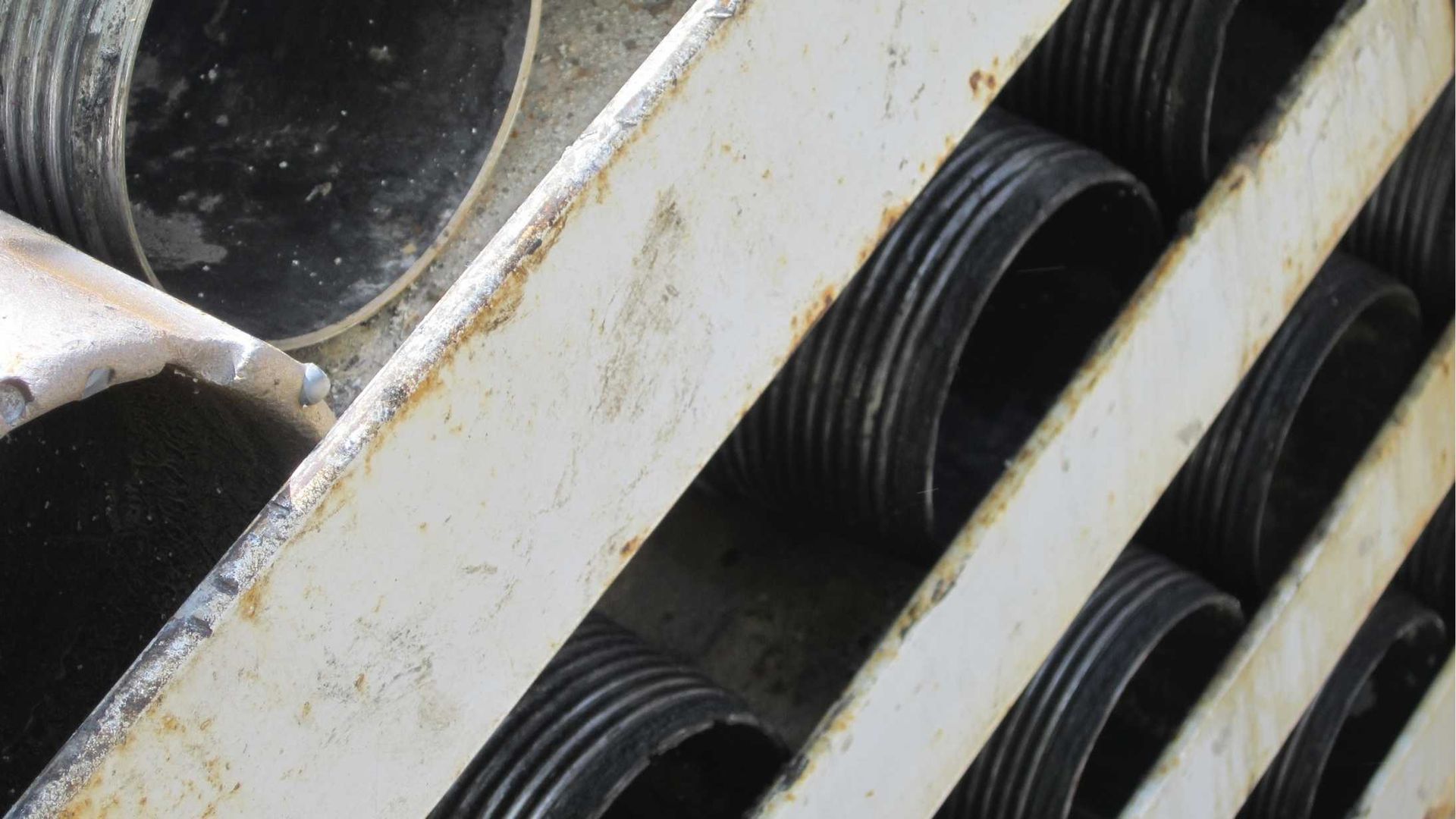 A row of metal pipes stacked on top of each other